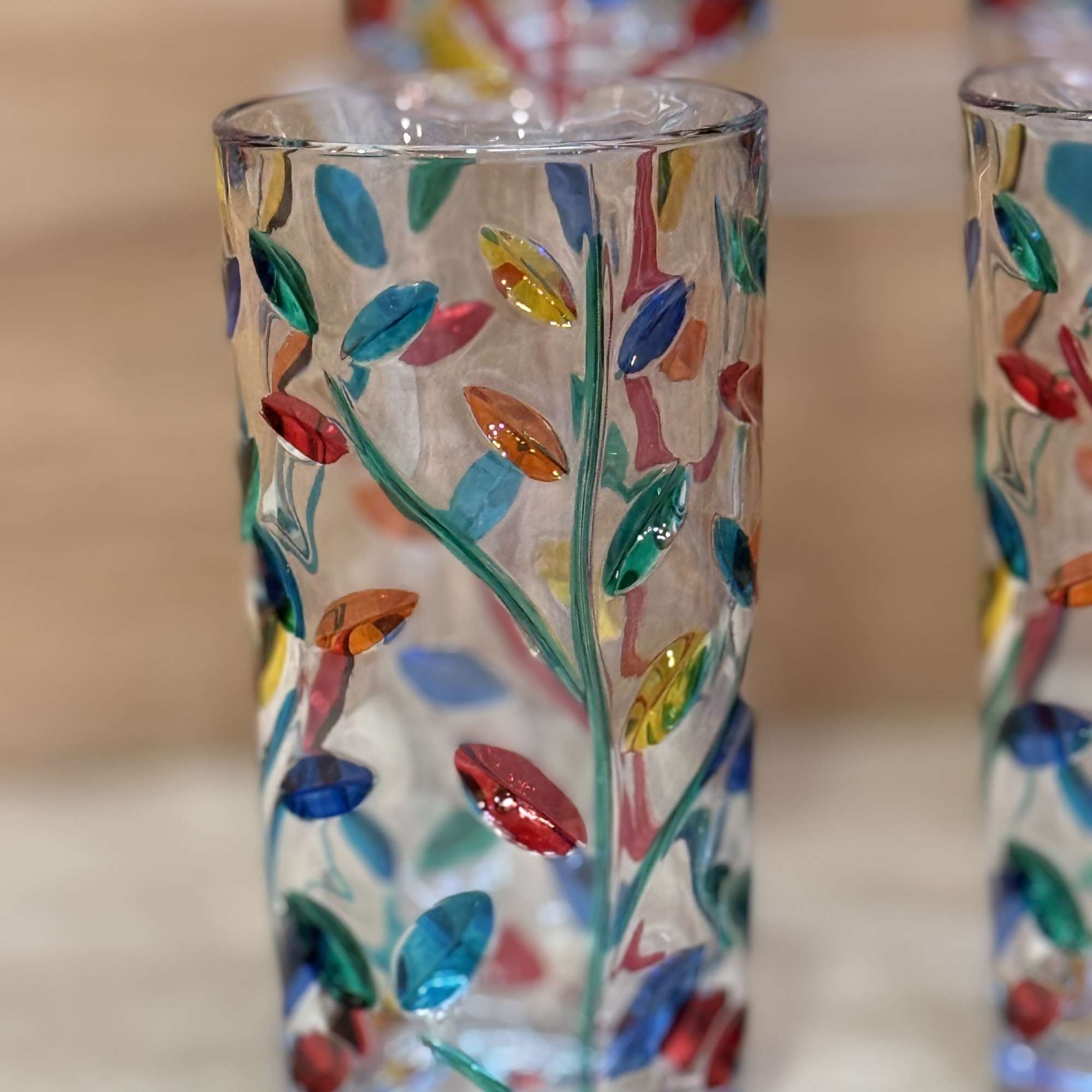 Colorful glass votive holder with leaf-like mosaic pattern