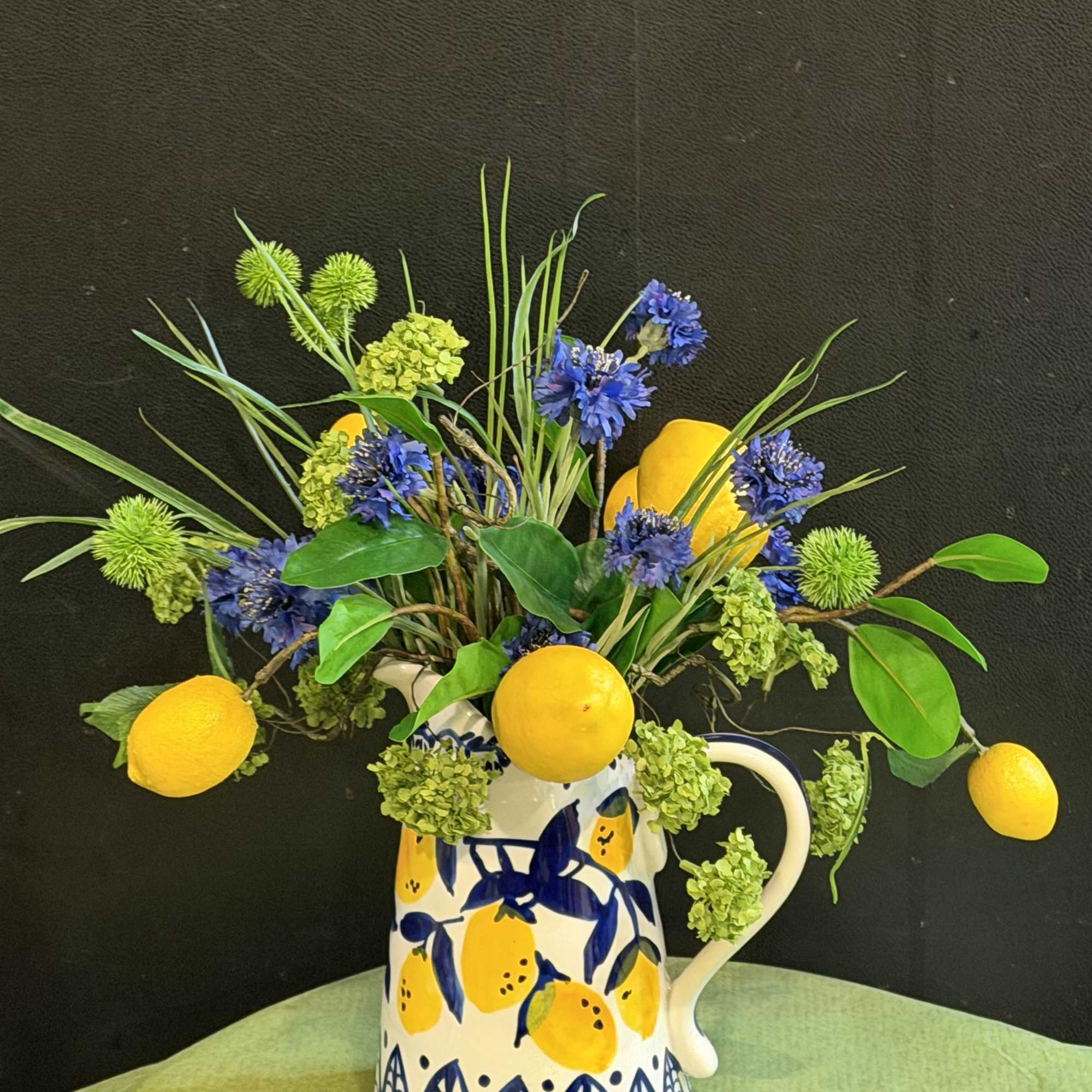A Tuscan-inspired silk arrangement bursting with lemons, sapphire cornflowers, and green botanicals, photo 2 of 2