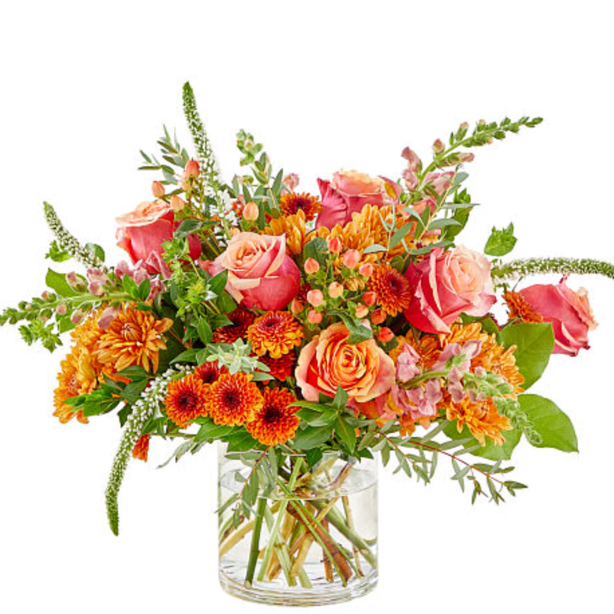Bouquet of pink roses and orange chrysanthemums in a clear glass vase