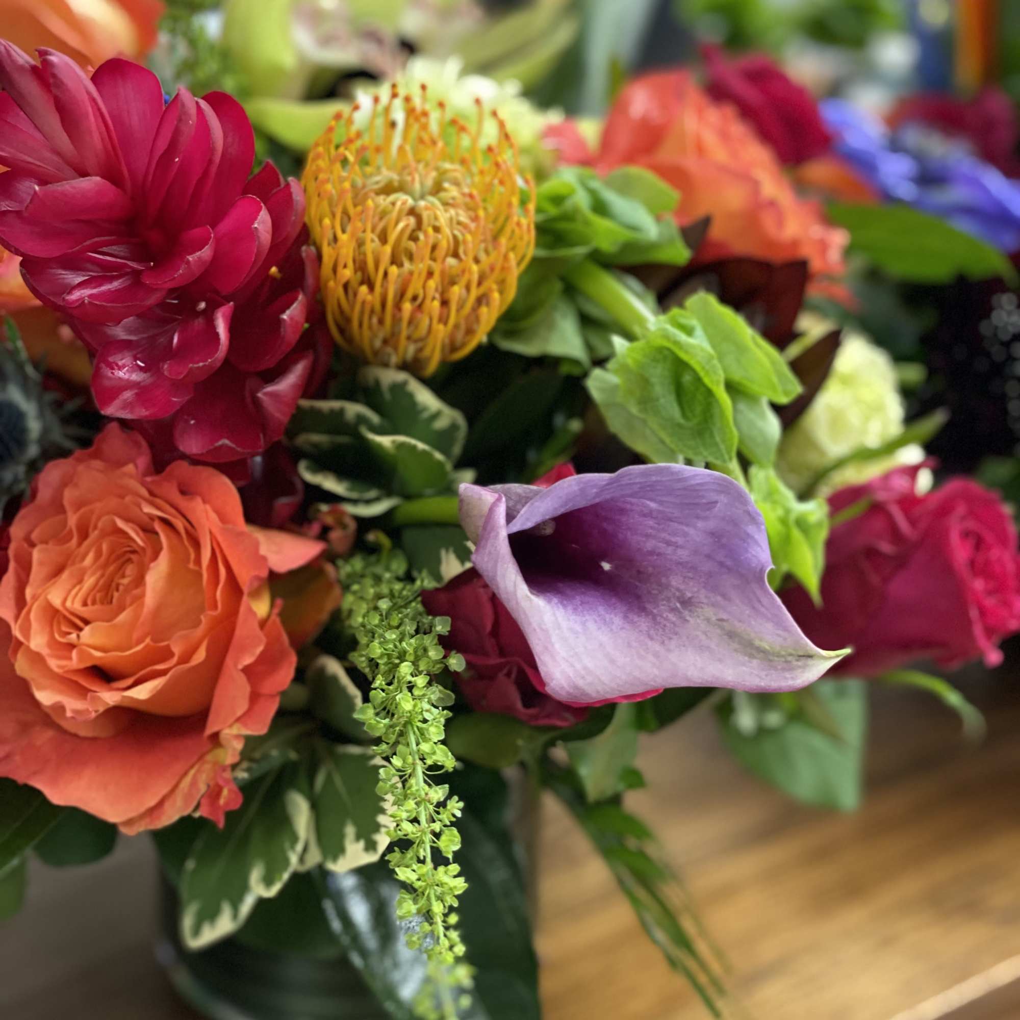Uniquely made tropical mix of exotic blooms and traditional flowers in a