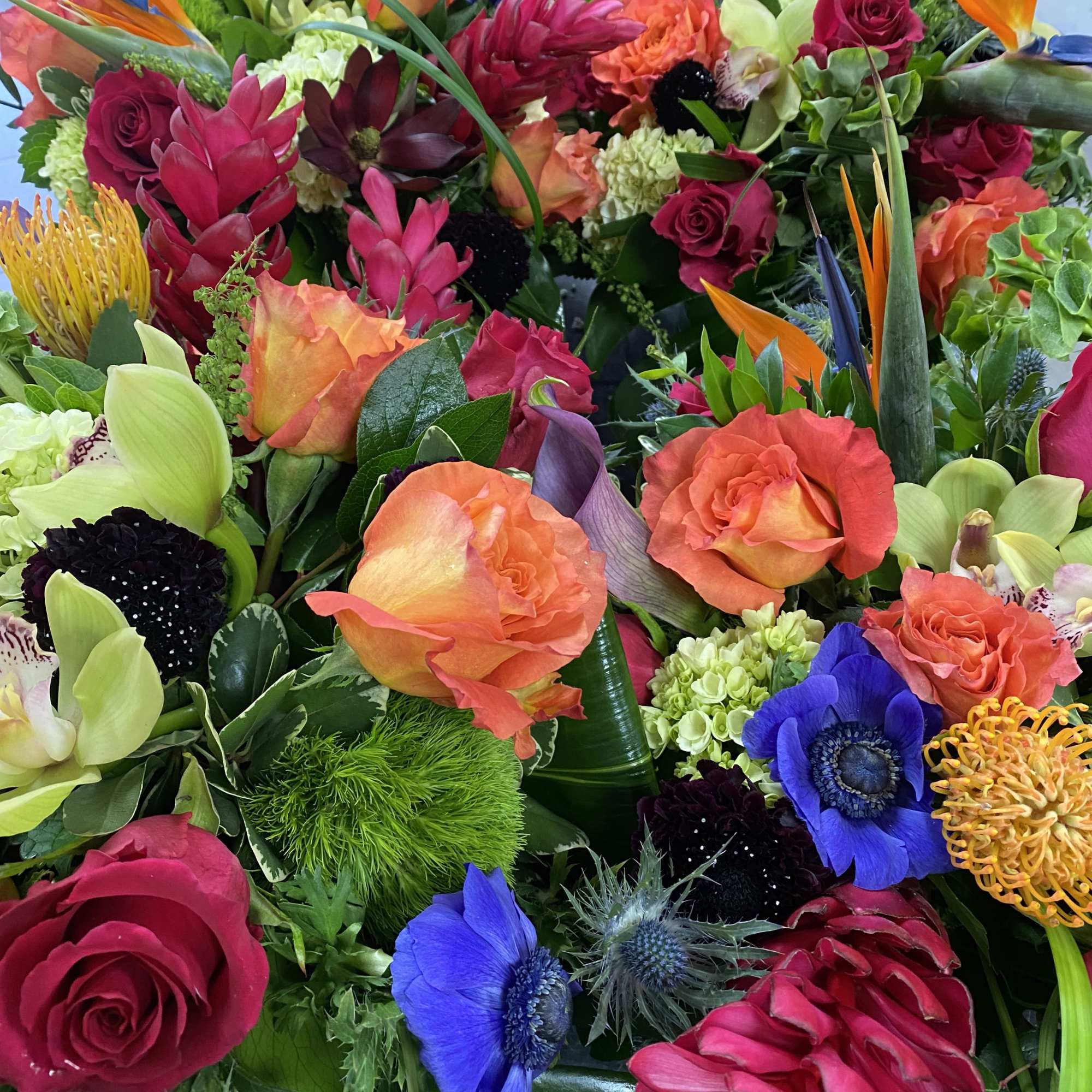 Uniquely made tropical mix of exotic blooms and traditional flowers in a, photo 2 of 3