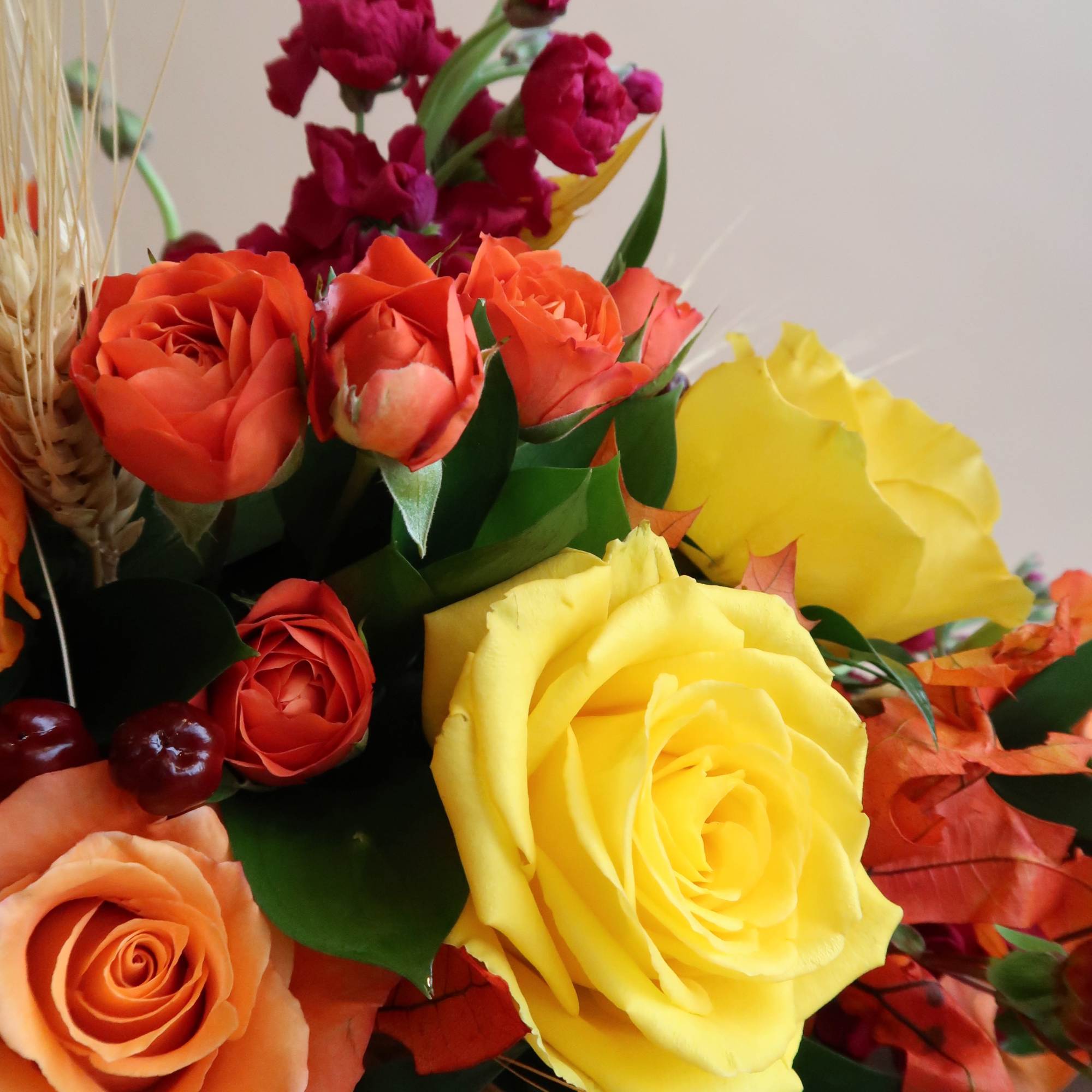 Colorful bouquet with yellow, orange, and red roses
