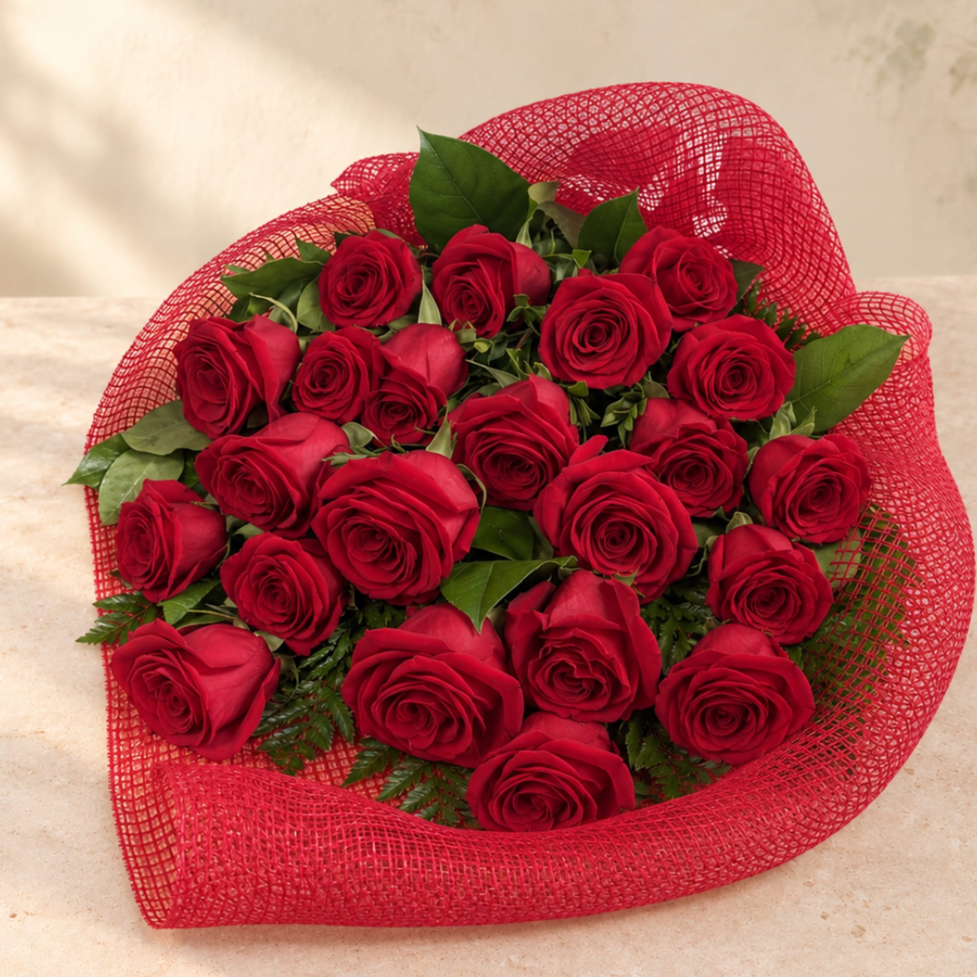 Bouquet of red roses wrapped in red mesh