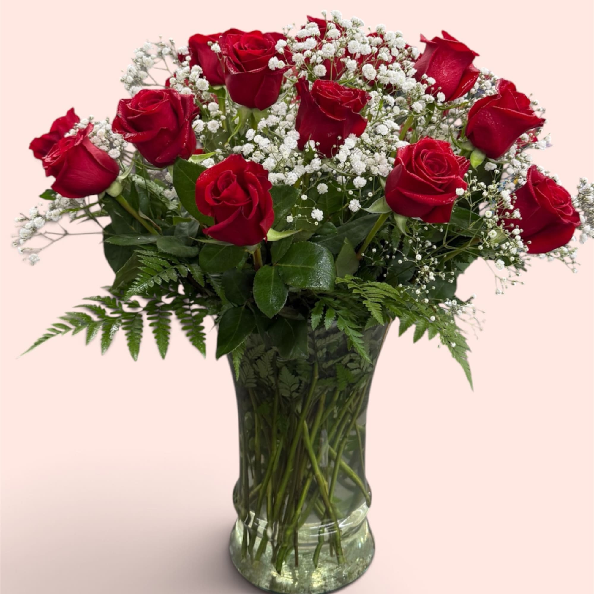 Red roses and white baby's breath in a clear glass vase, photo 2 of 2