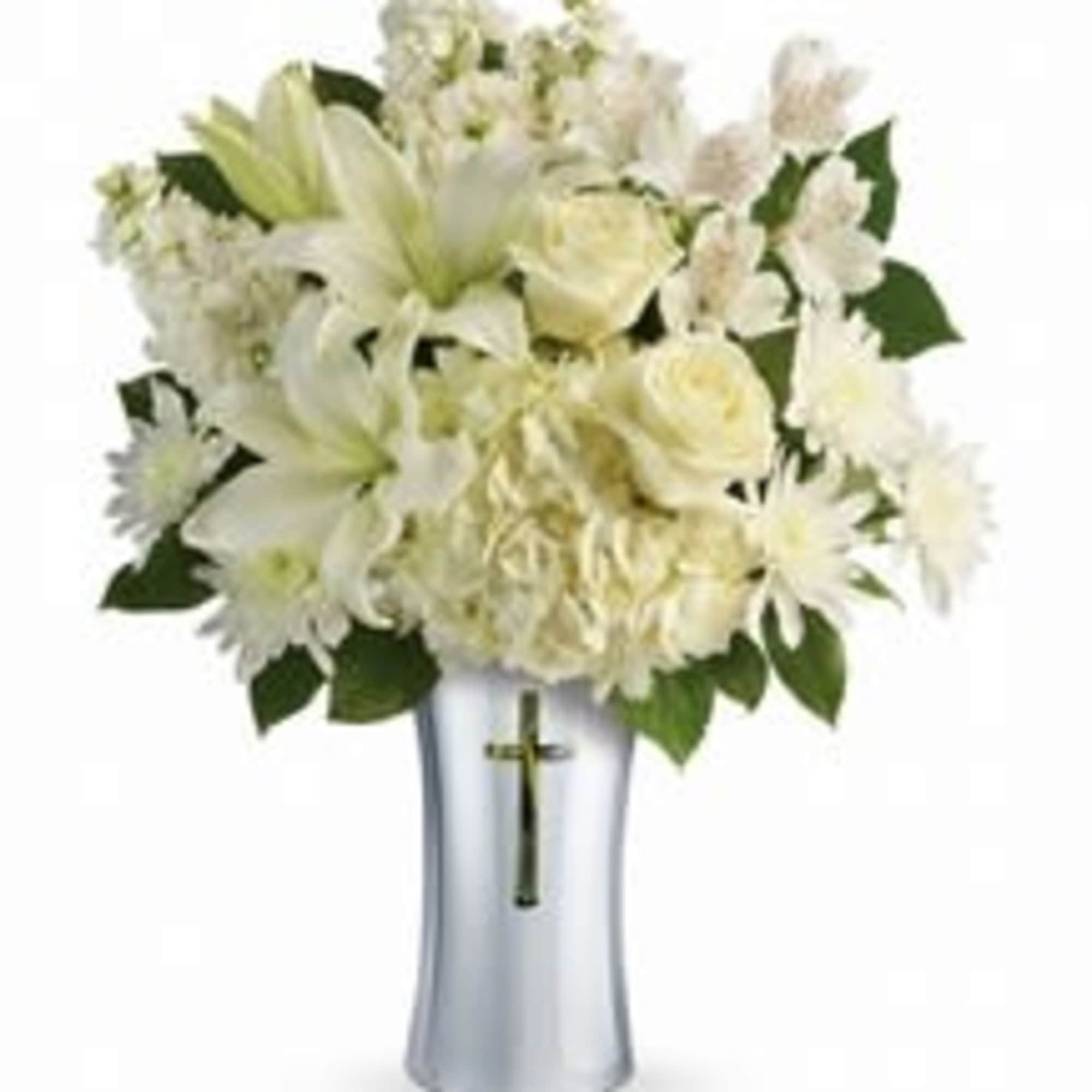 White floral arrangement in a silver vase with a cross