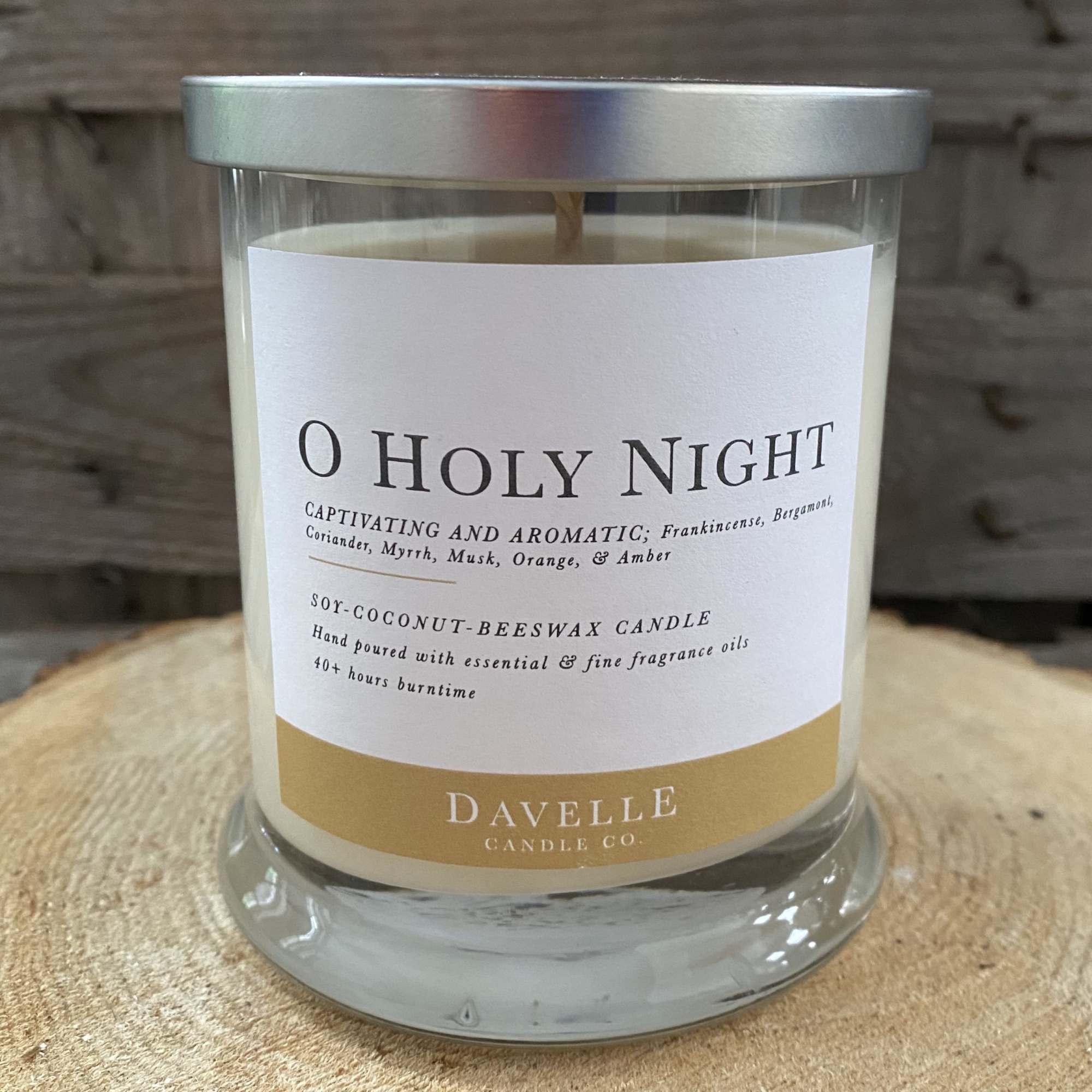 Glass jar candle with a silver lid and labeled "O Holy Night"