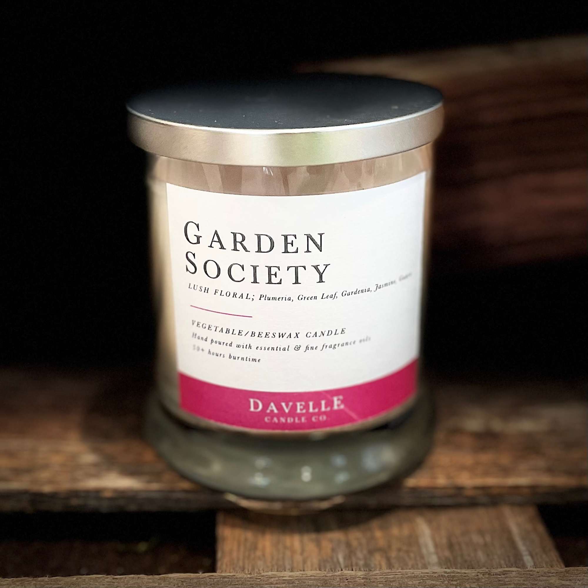 A scented candle in a glass jar with a metal lid