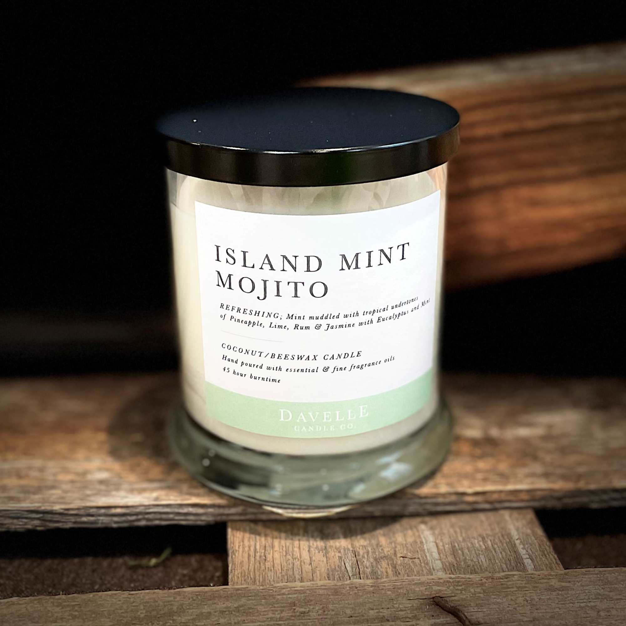 Glass jar candle with a black lid and Island Mint Mojito label