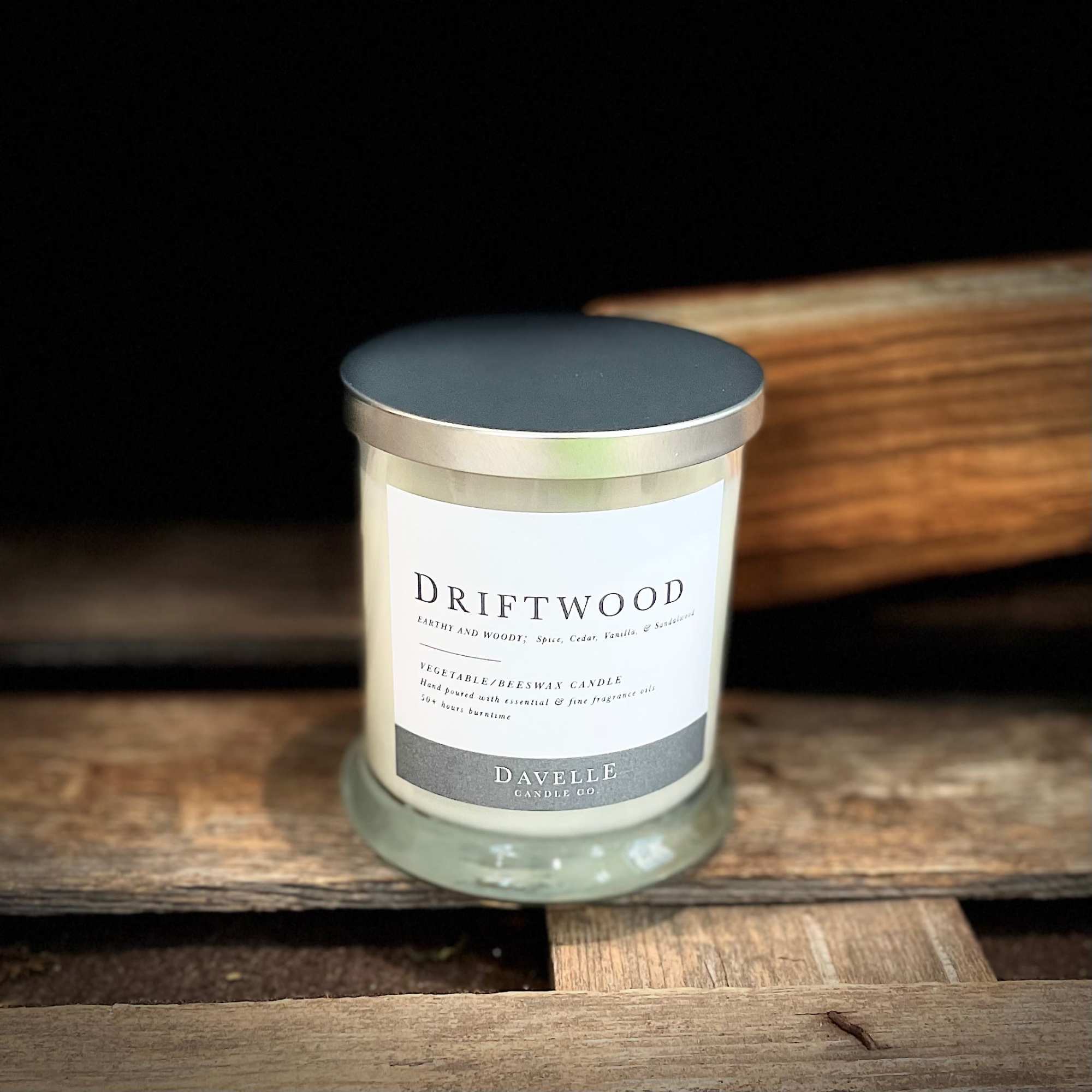 Driftwood-scented candle in a glass jar with a metal lid