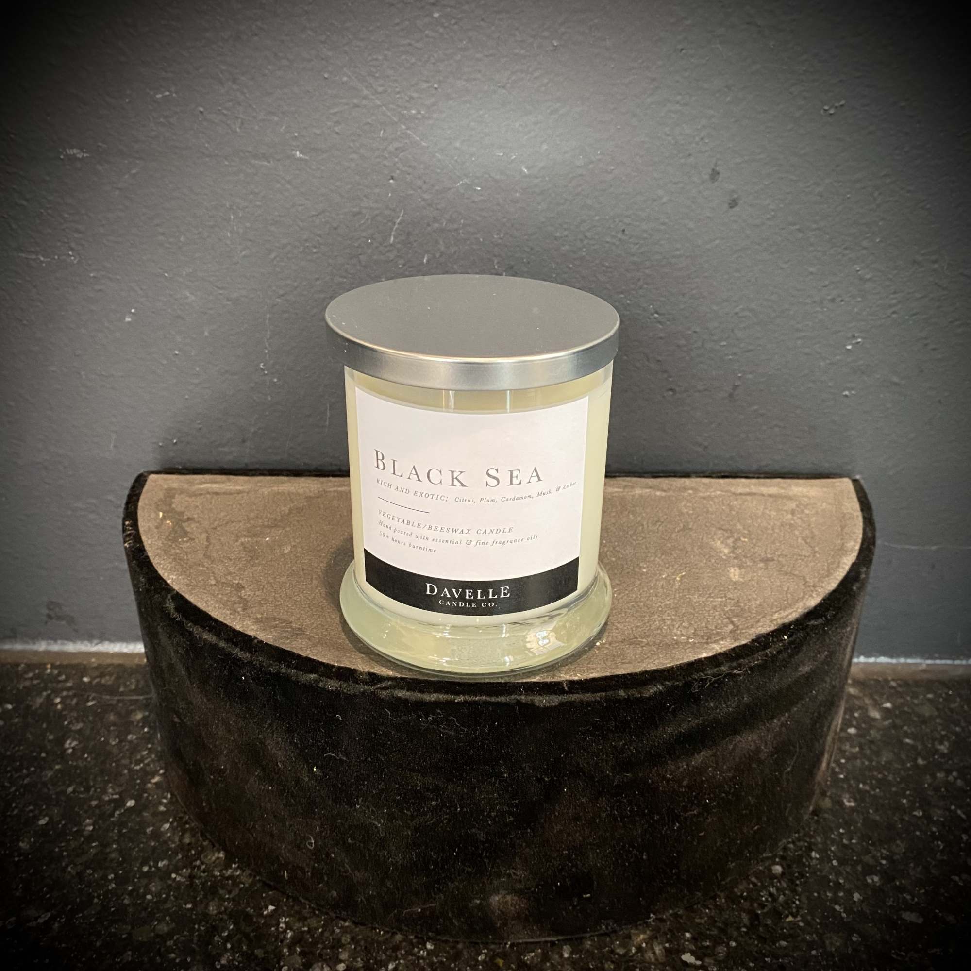 Scented candle in a glass jar with a silver lid