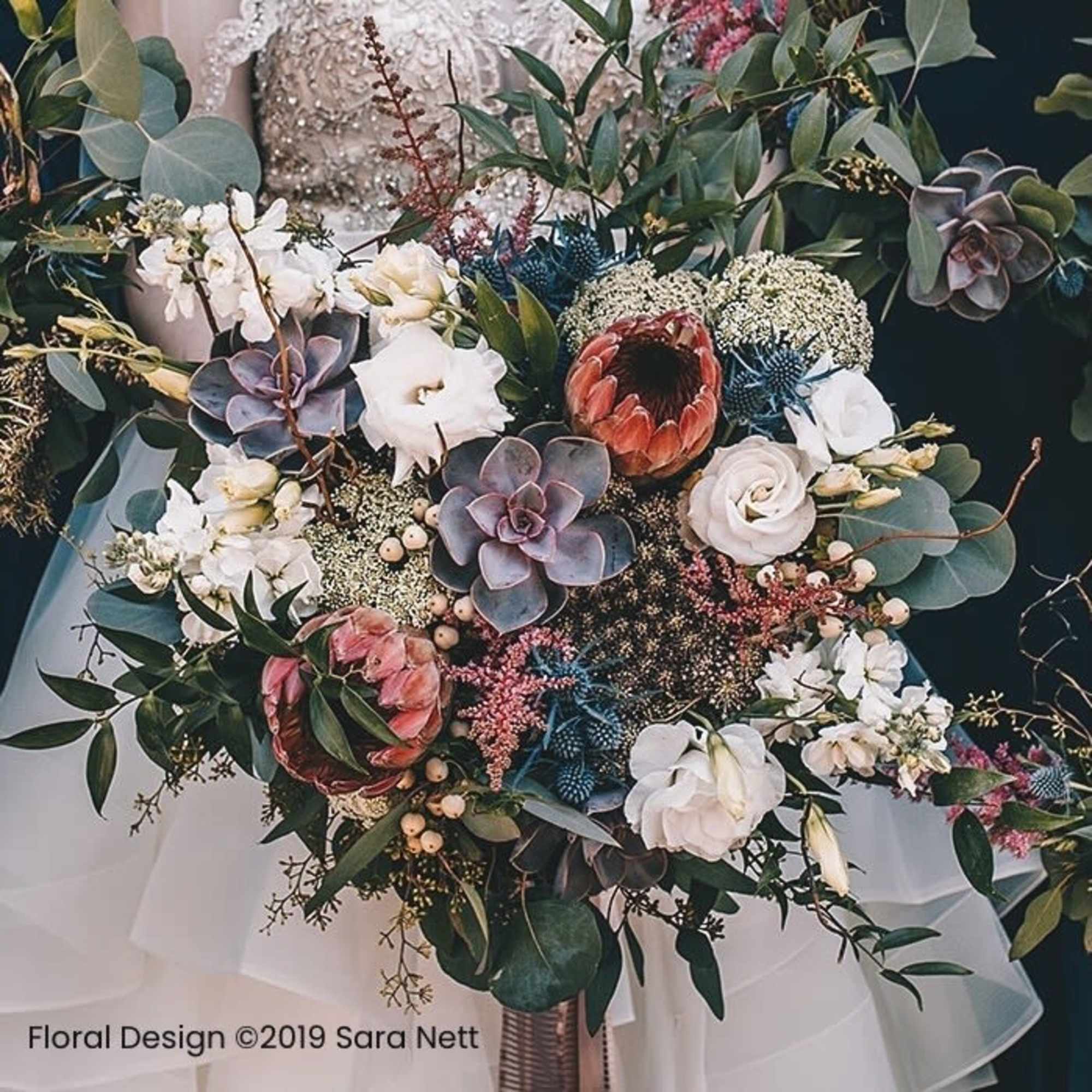 Large bouquet with white and coral flowers, succulents, and greenery