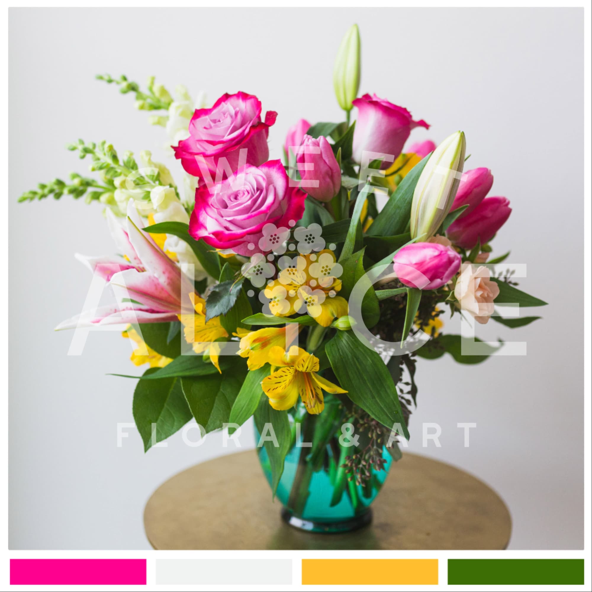 Bouquet of pink roses, lilies, and yellow flowers in a teal vase