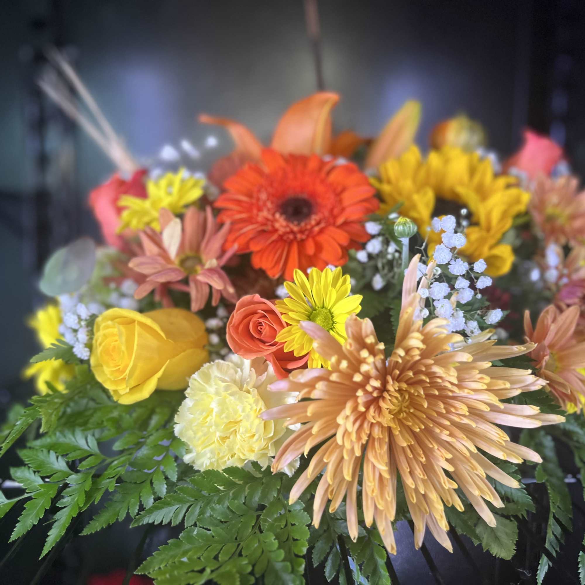 Mixed bouquet with orange, yellow, and pink flowers