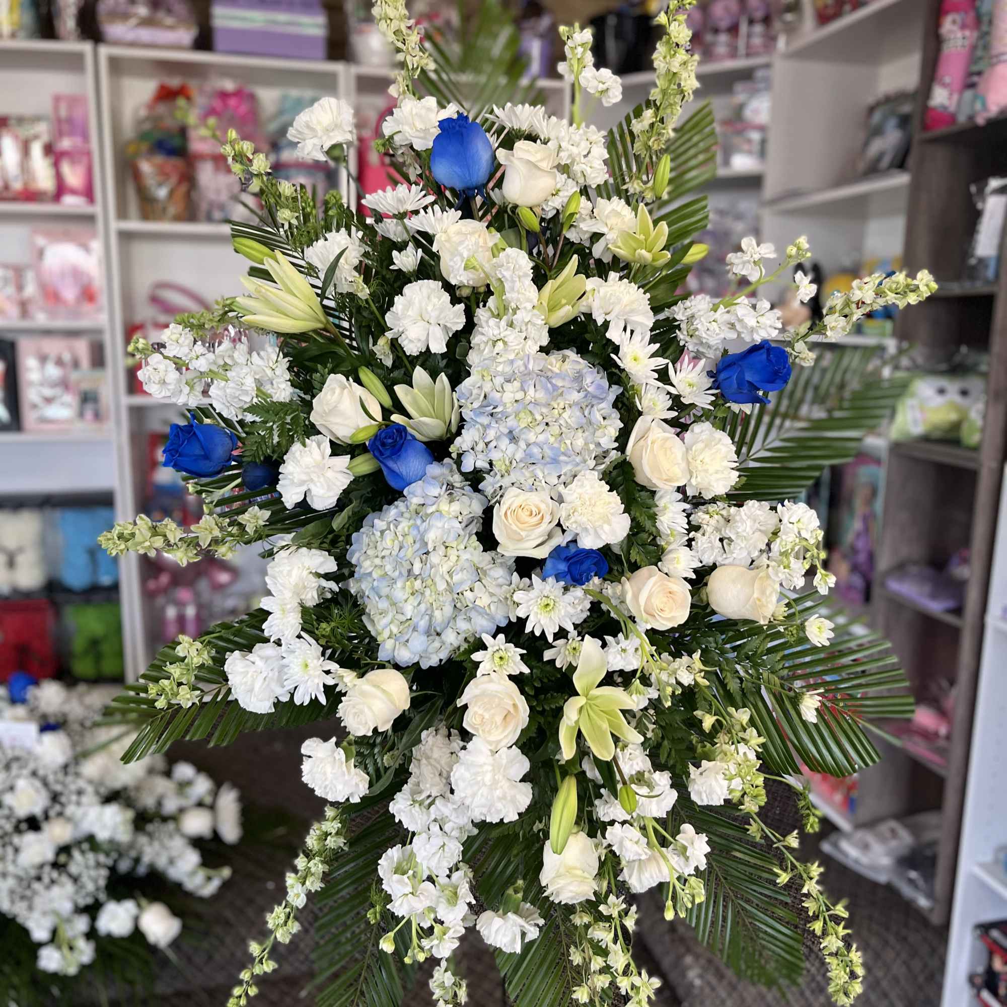 Large standing floral spray with white and blue flowers