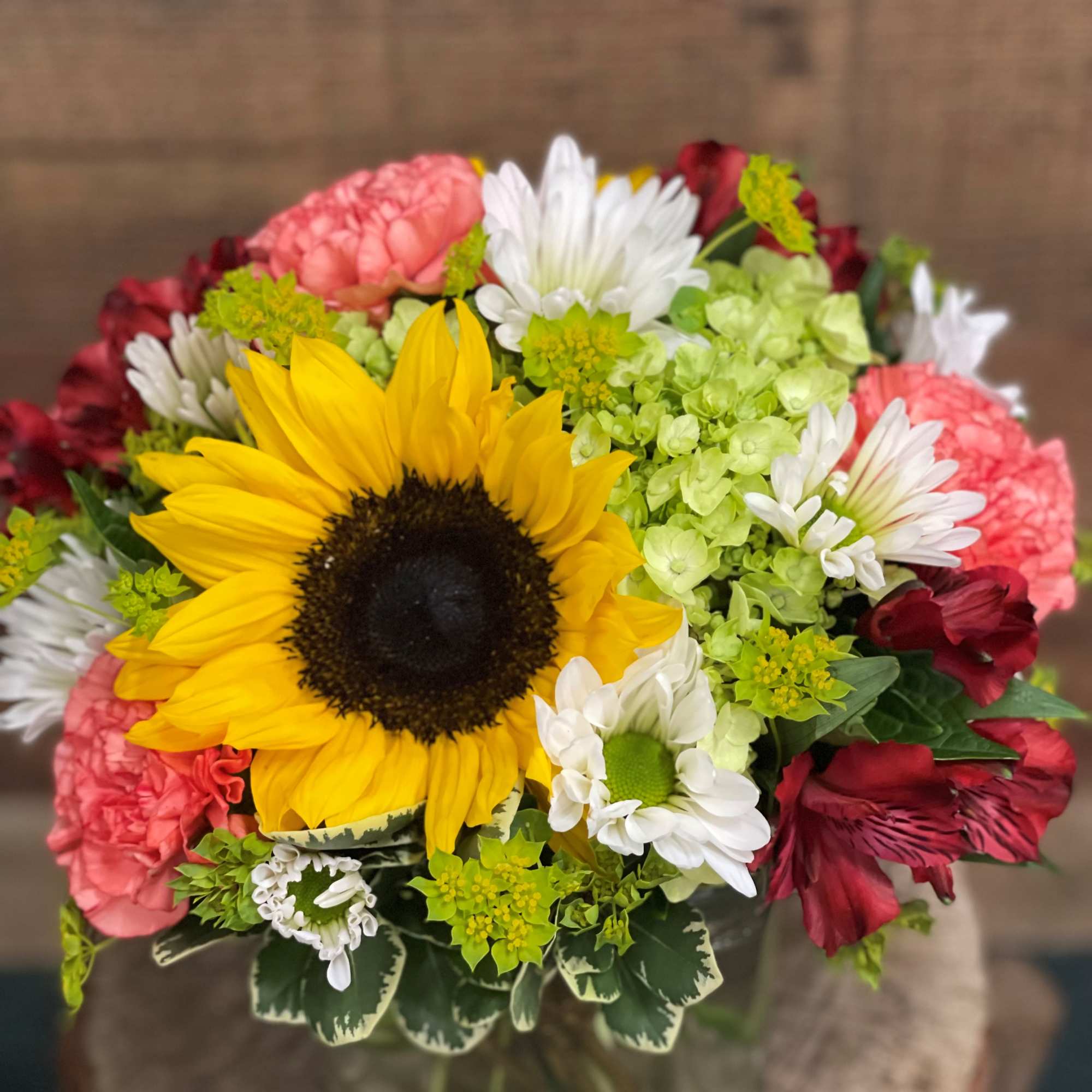 Sunny sunflowers artfully paired with bright and summery long lasting flowers. Nestled, photo 2 of 2