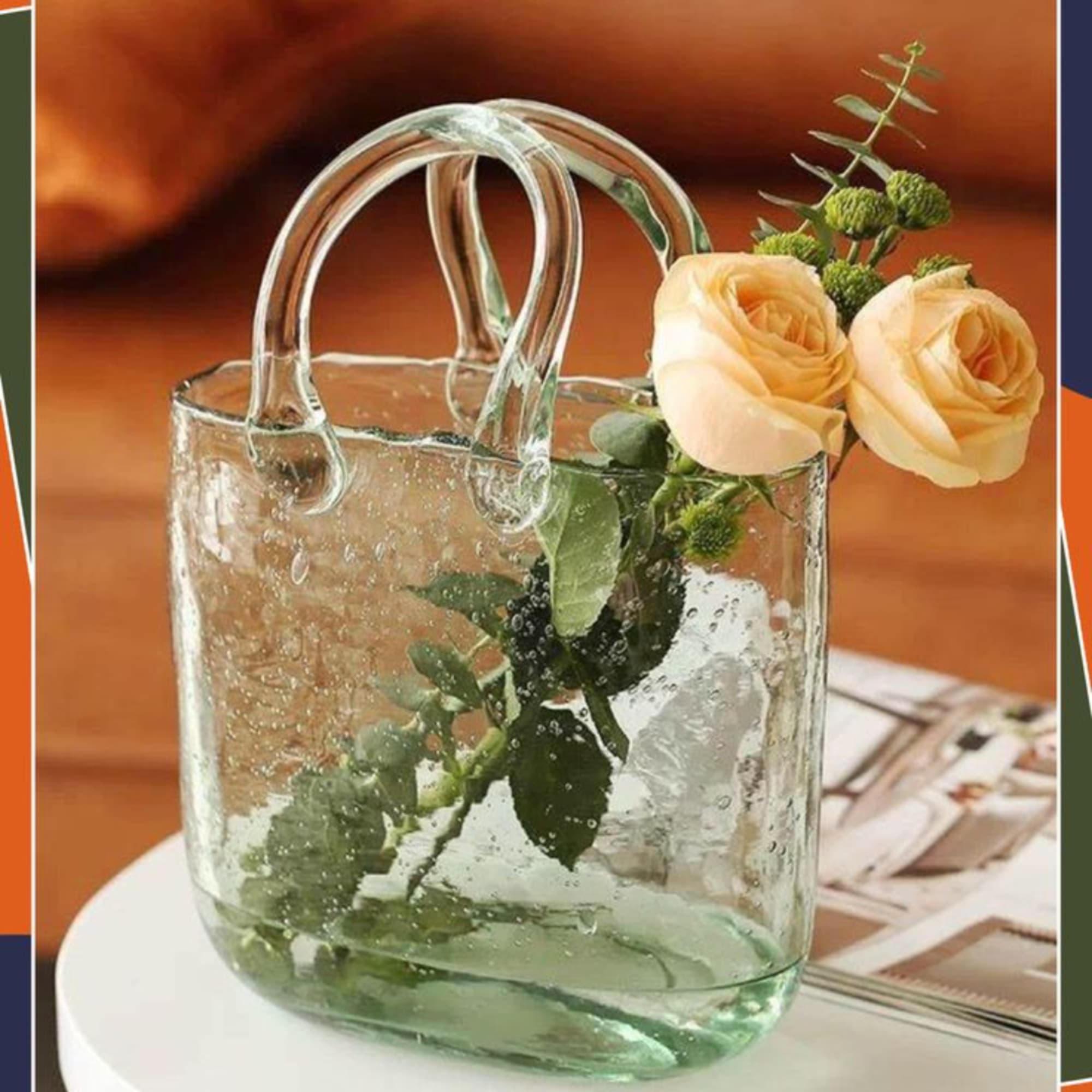 Two peach roses in a clear glass handbag-shaped vase