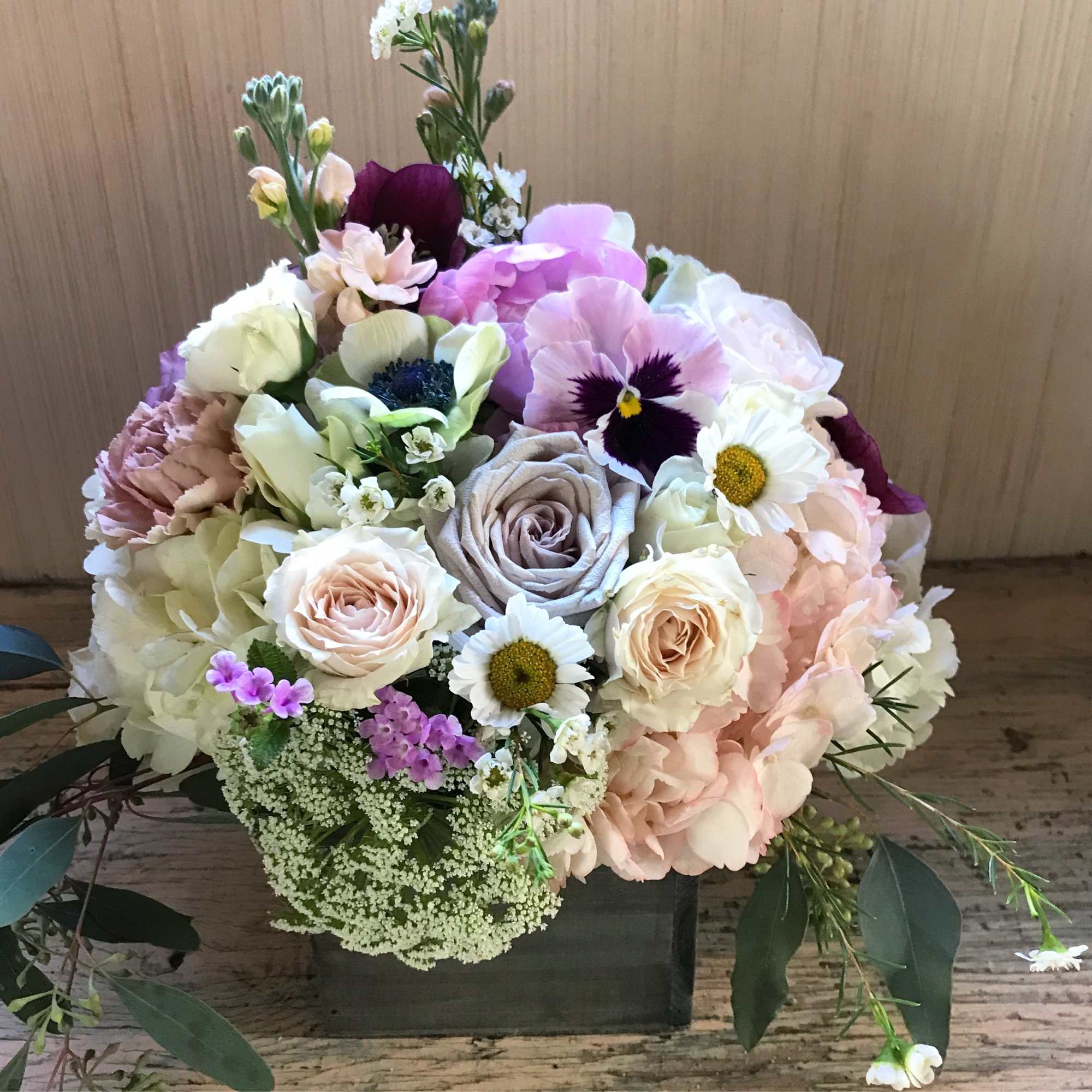 Gorgeous wooden box packed with pastel colored flowers. For the hippie, the