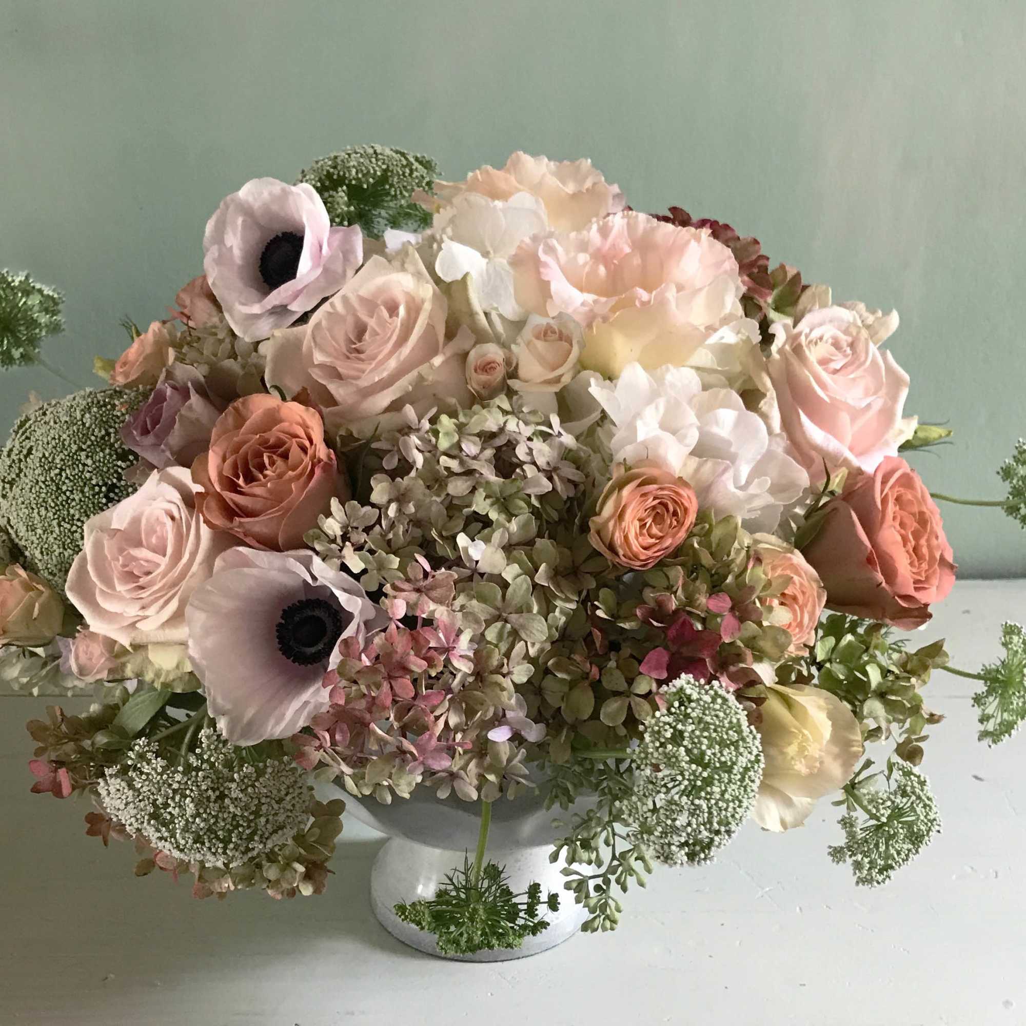 Perfect palette of nude and blushing fresh flowers arranged in a classic, photo 2 of 4