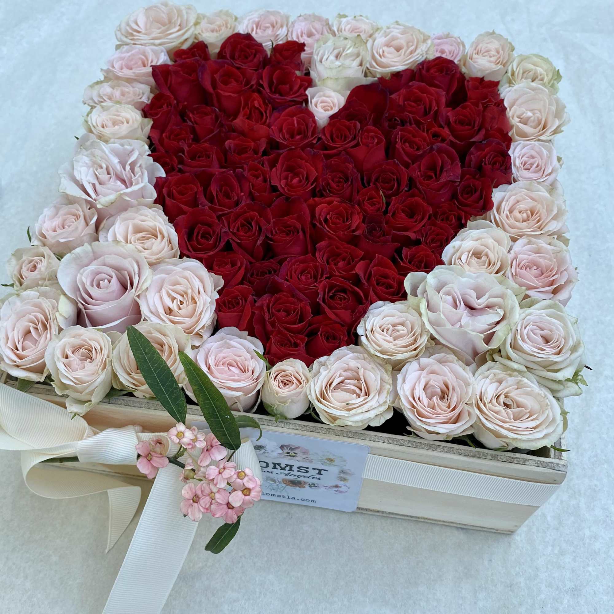 Heart-shaped box filled with red and blush roses