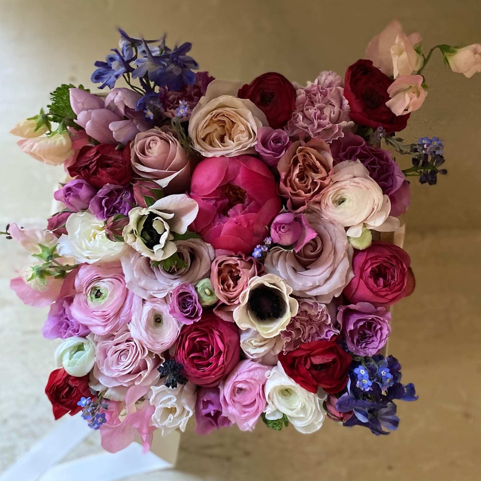 Dense bouquet of pink, red, and purple flowers