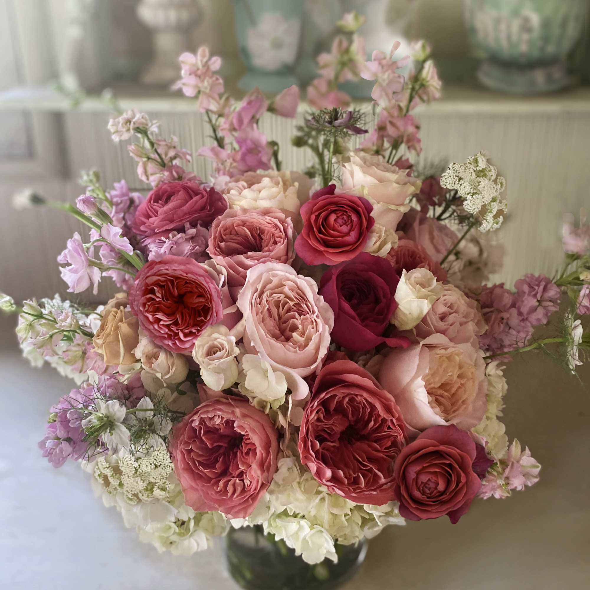 Pink and cream rose bouquet in a glass vase