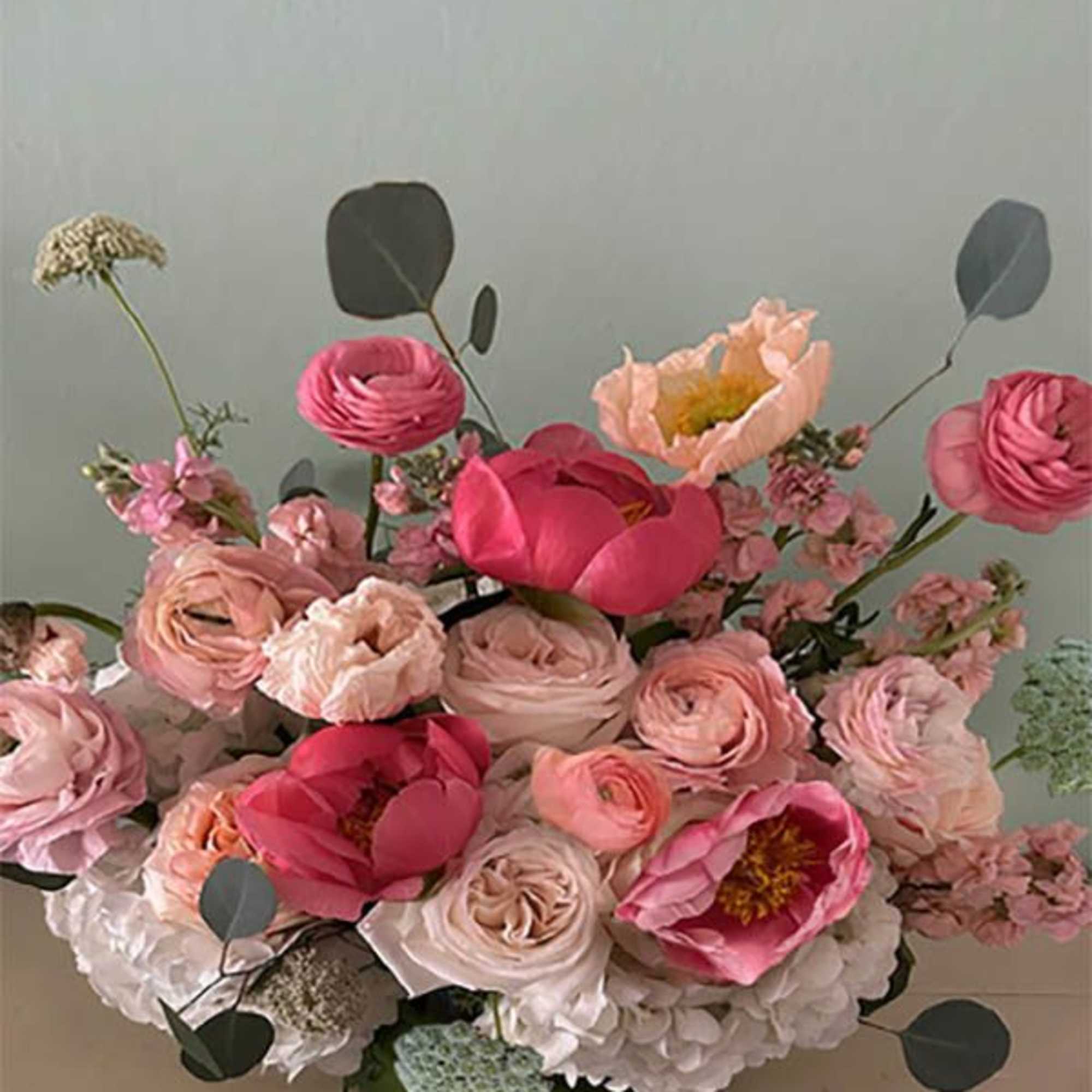 Pink and blush floral arrangement in a green vase, photo 2 of 2