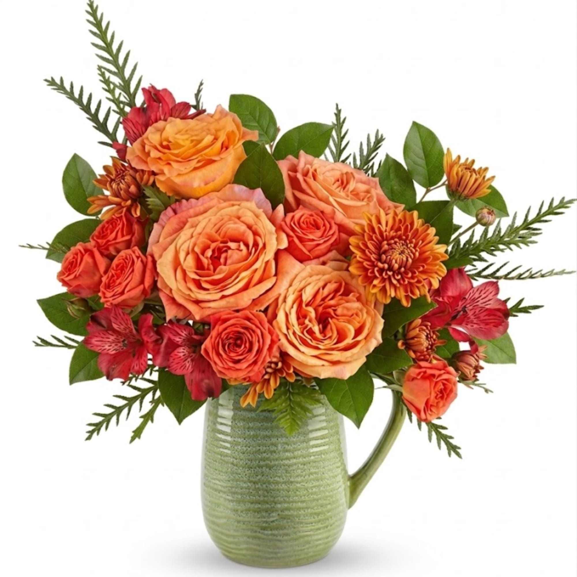 Orange and coral flower bouquet in a green ceramic pitcher vase