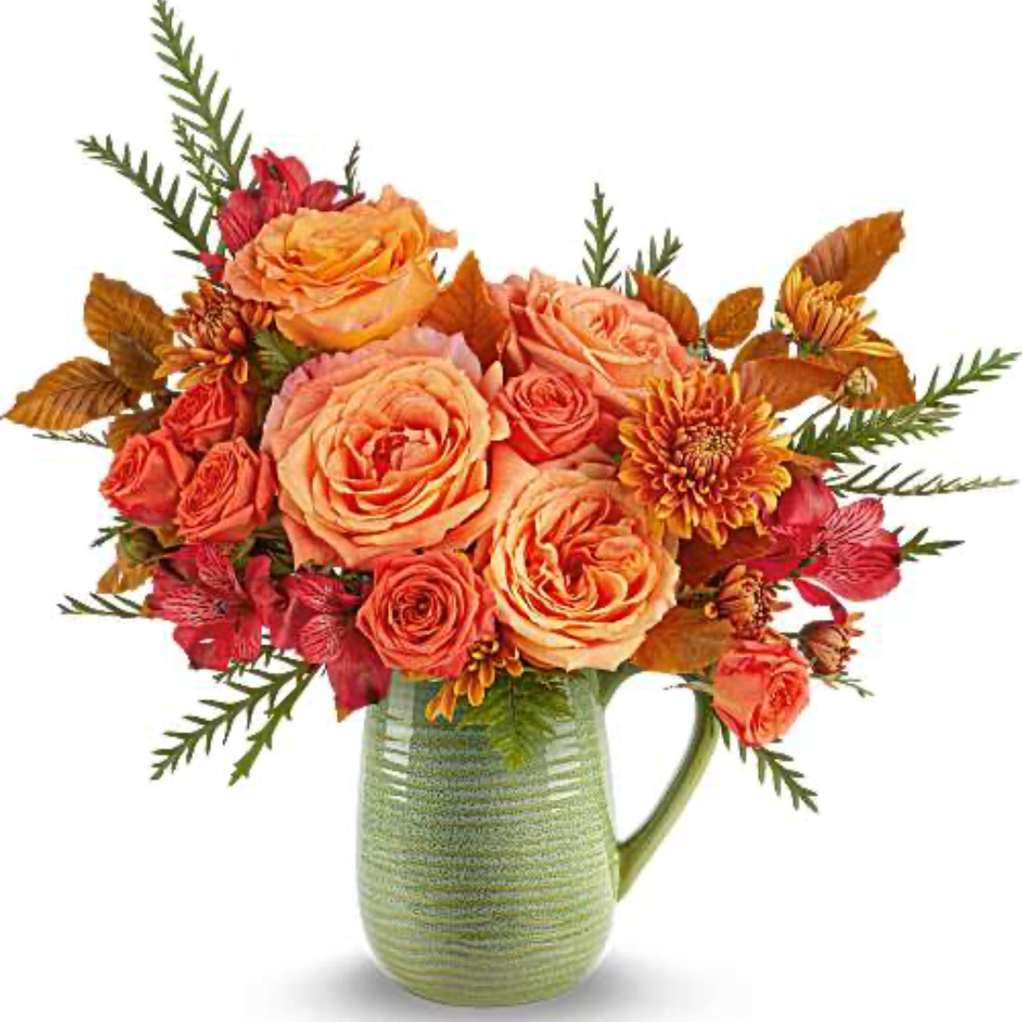 Orange and red flower arrangement in a green ceramic pitcher