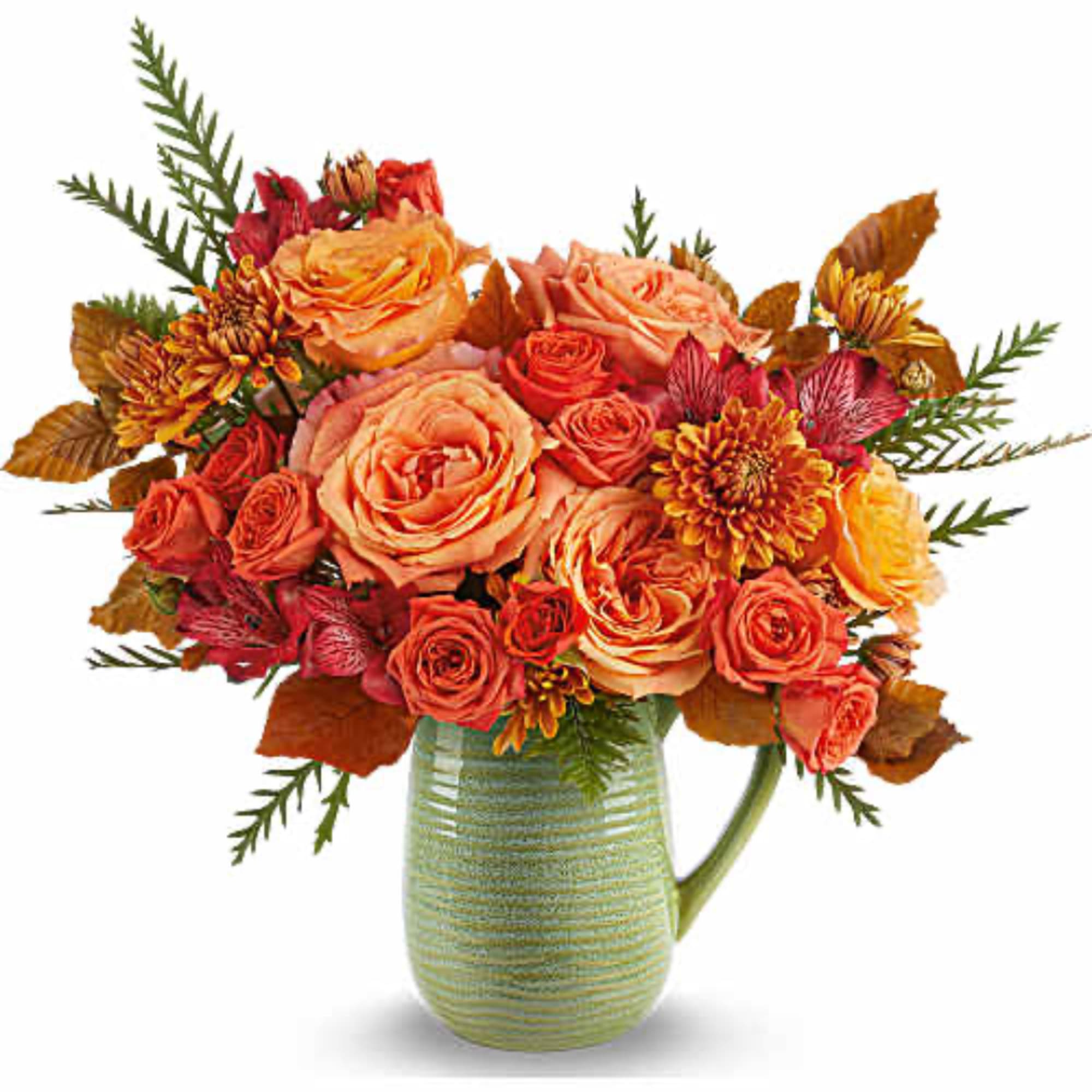 Orange and coral rose bouquet in a green ceramic pitcher