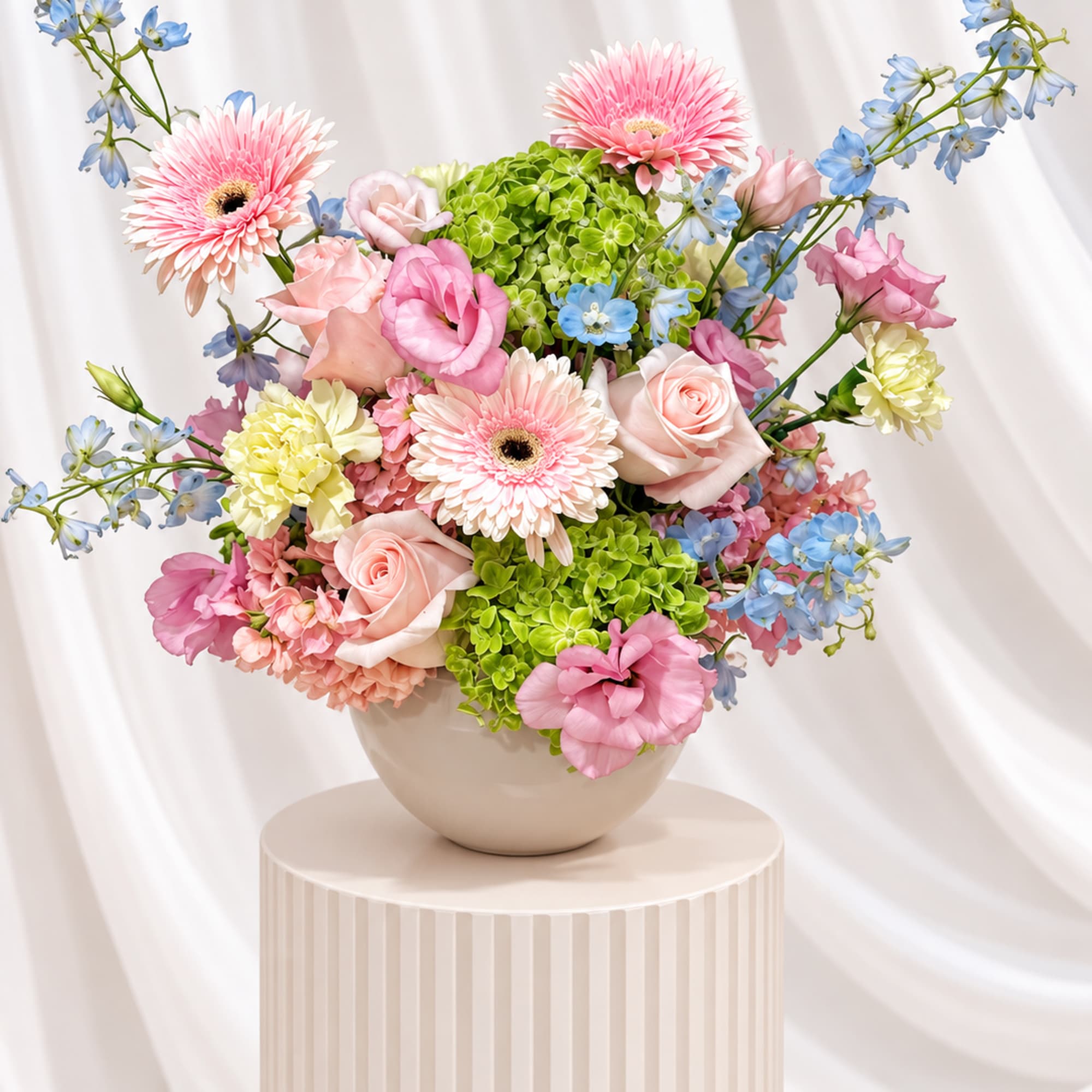 Pink and blue mixed bouquet in a round vase