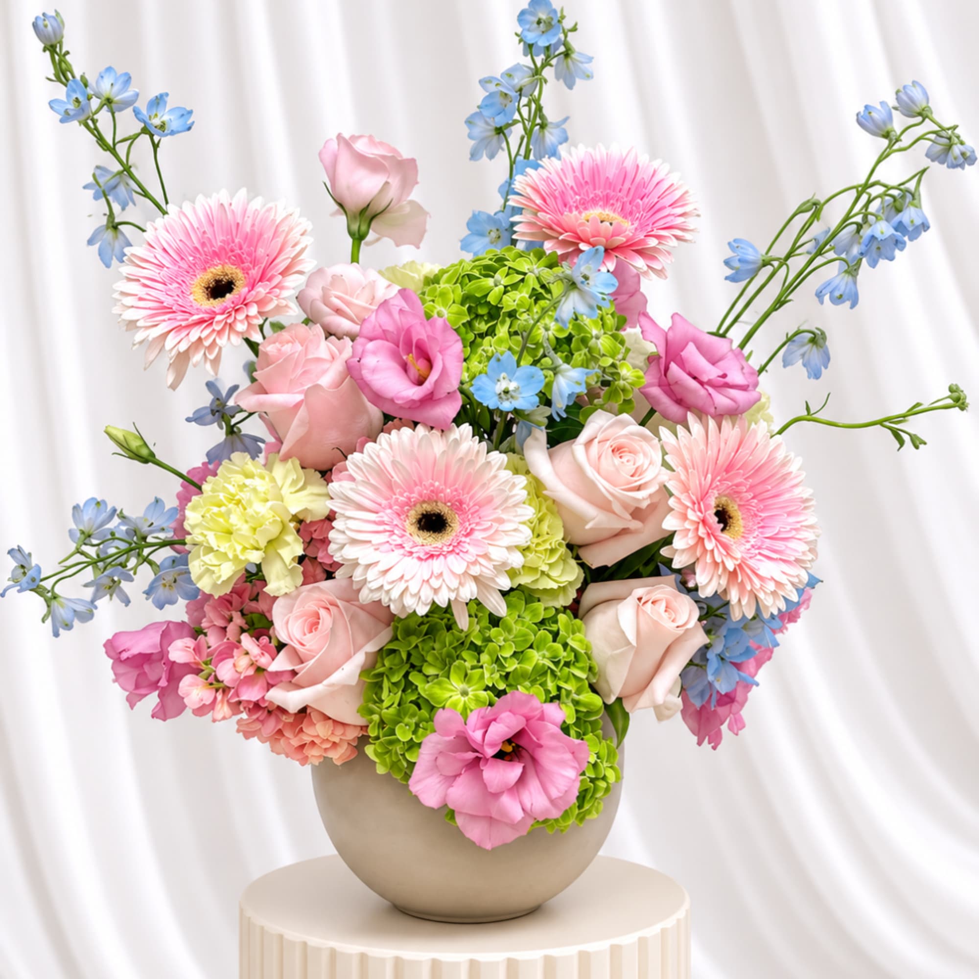 Pink and blue mixed bouquet in a round vase