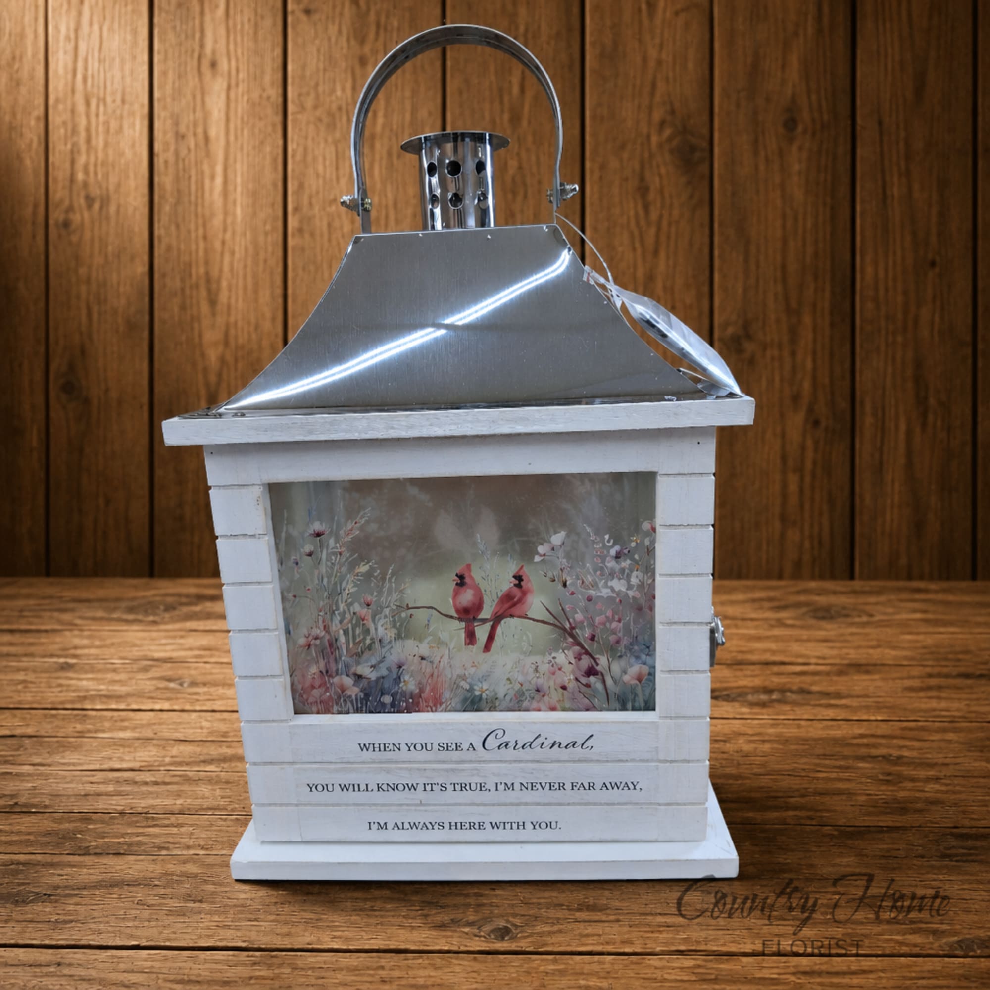 Decorative lantern with a cardinal illustration and memorial text