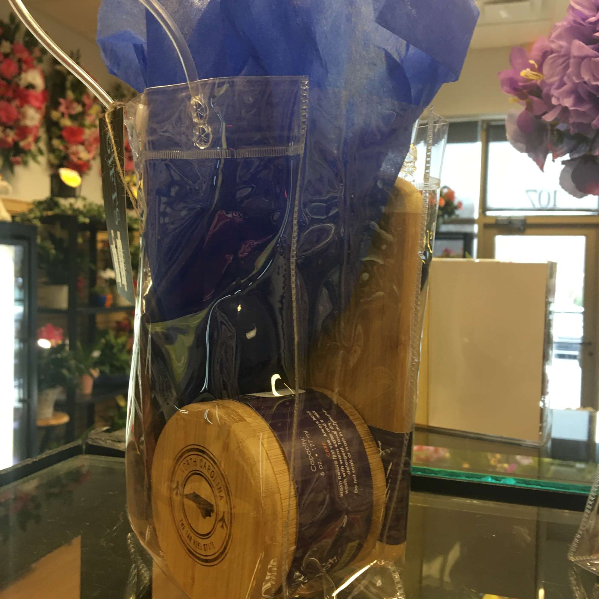 Gift basket with a blue tissue wrap and a jar of spread inside