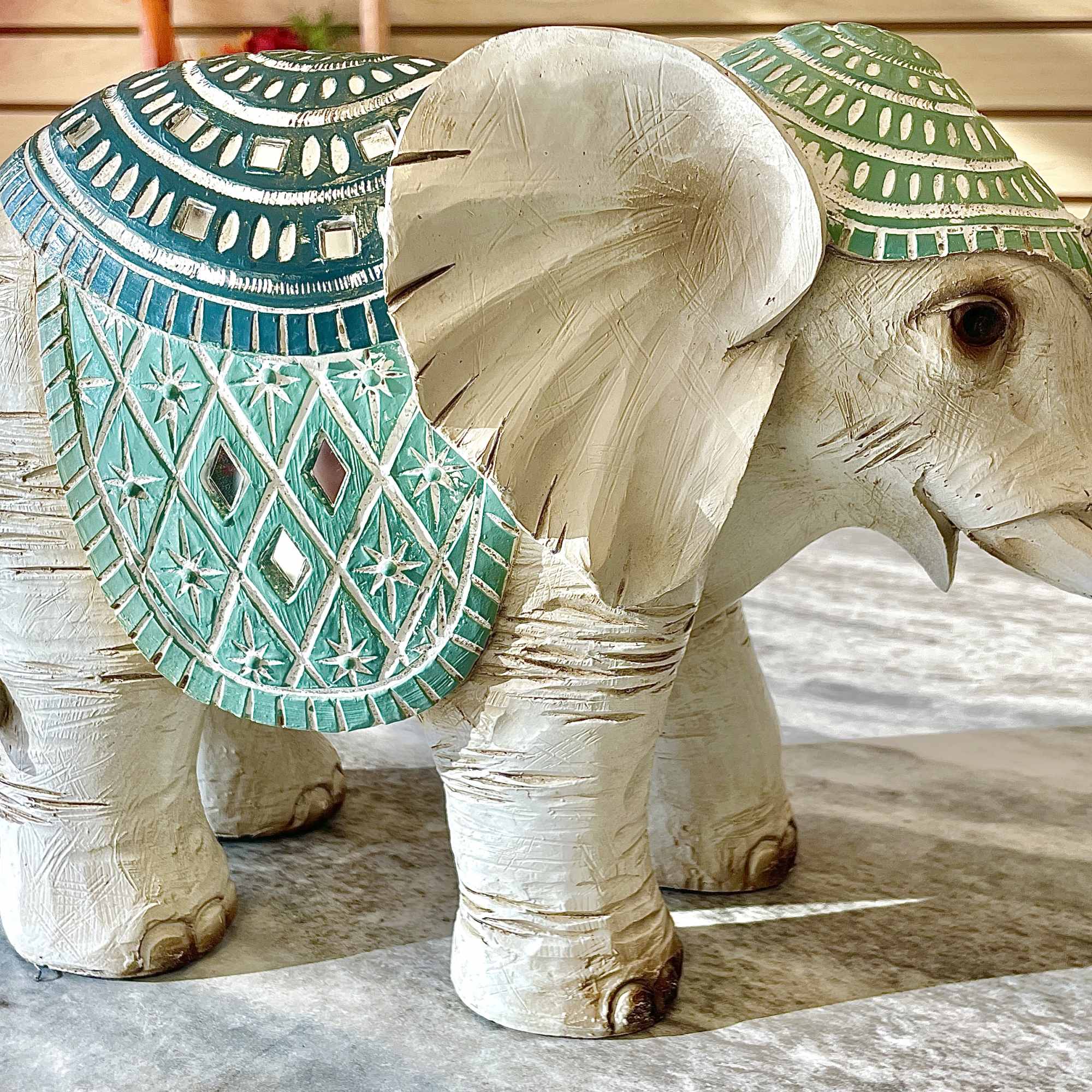 Decorative elephant figurine with turquoise patterned saddle