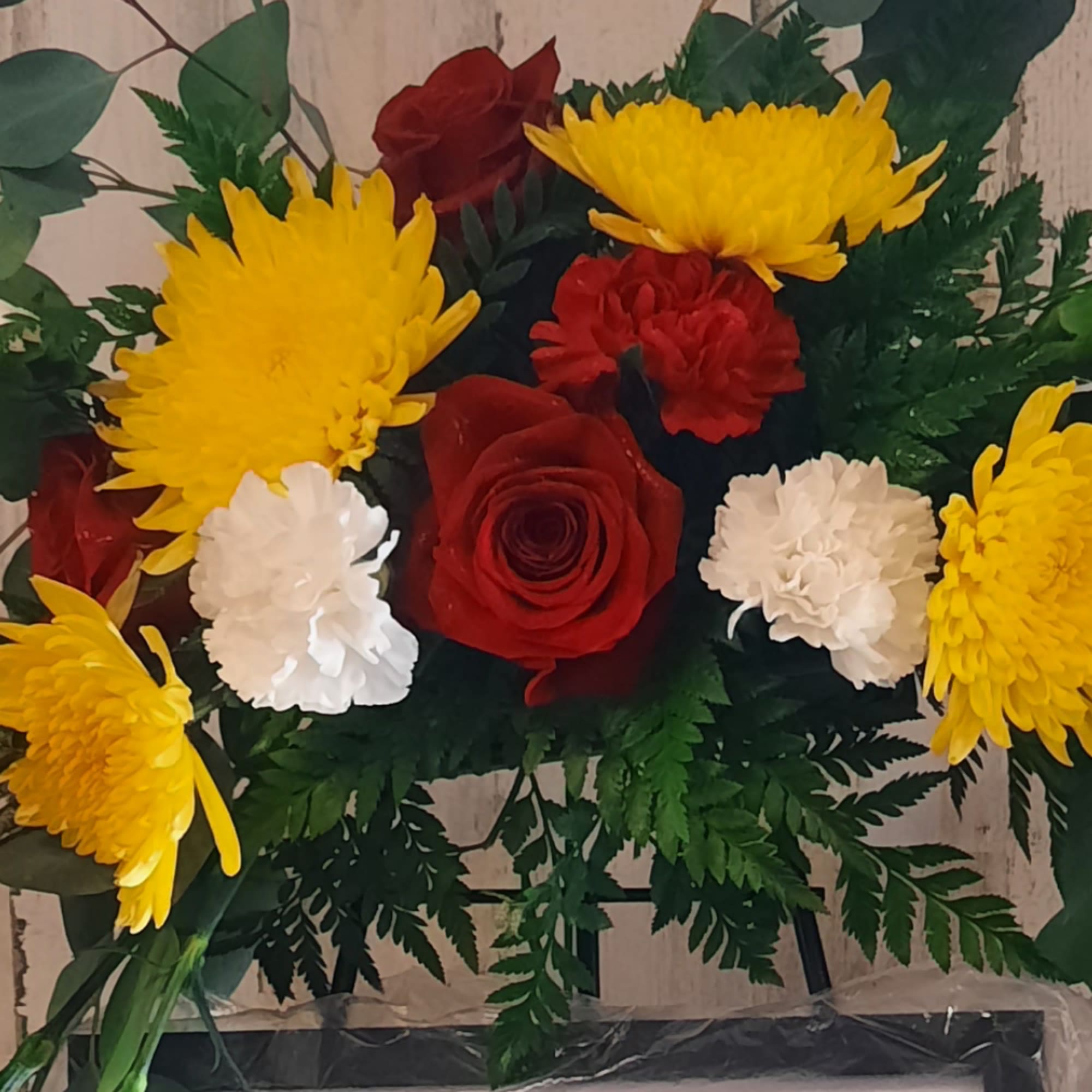 Bouquet of red roses, yellow chrysanthemums, and white carnations