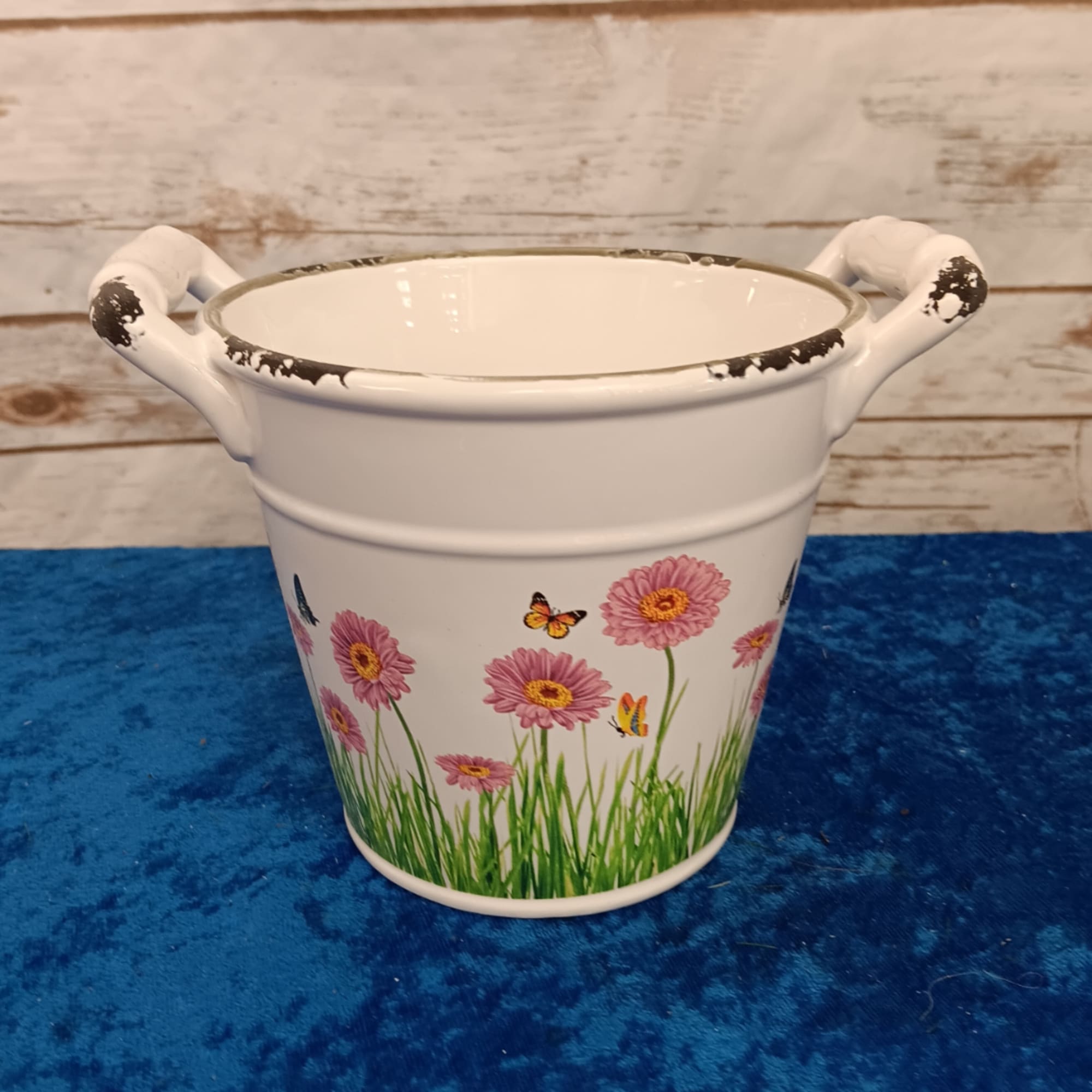 White metal bucket with pink flower print and side handles