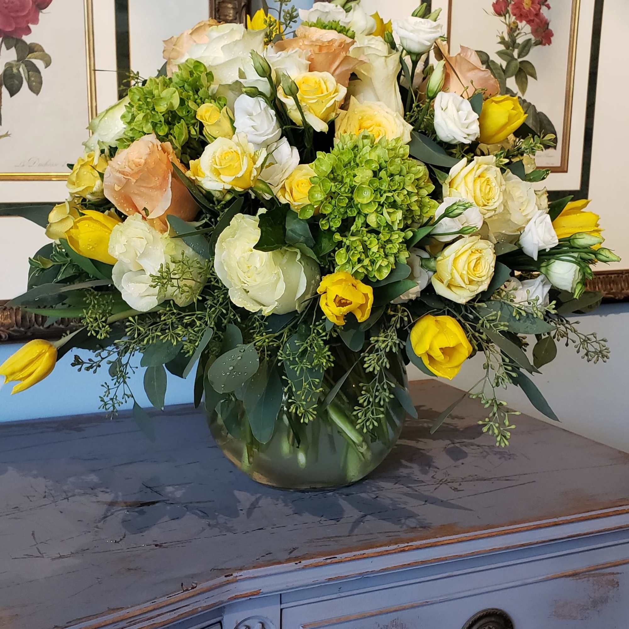 Yellow and white rose bouquet in a glass vase