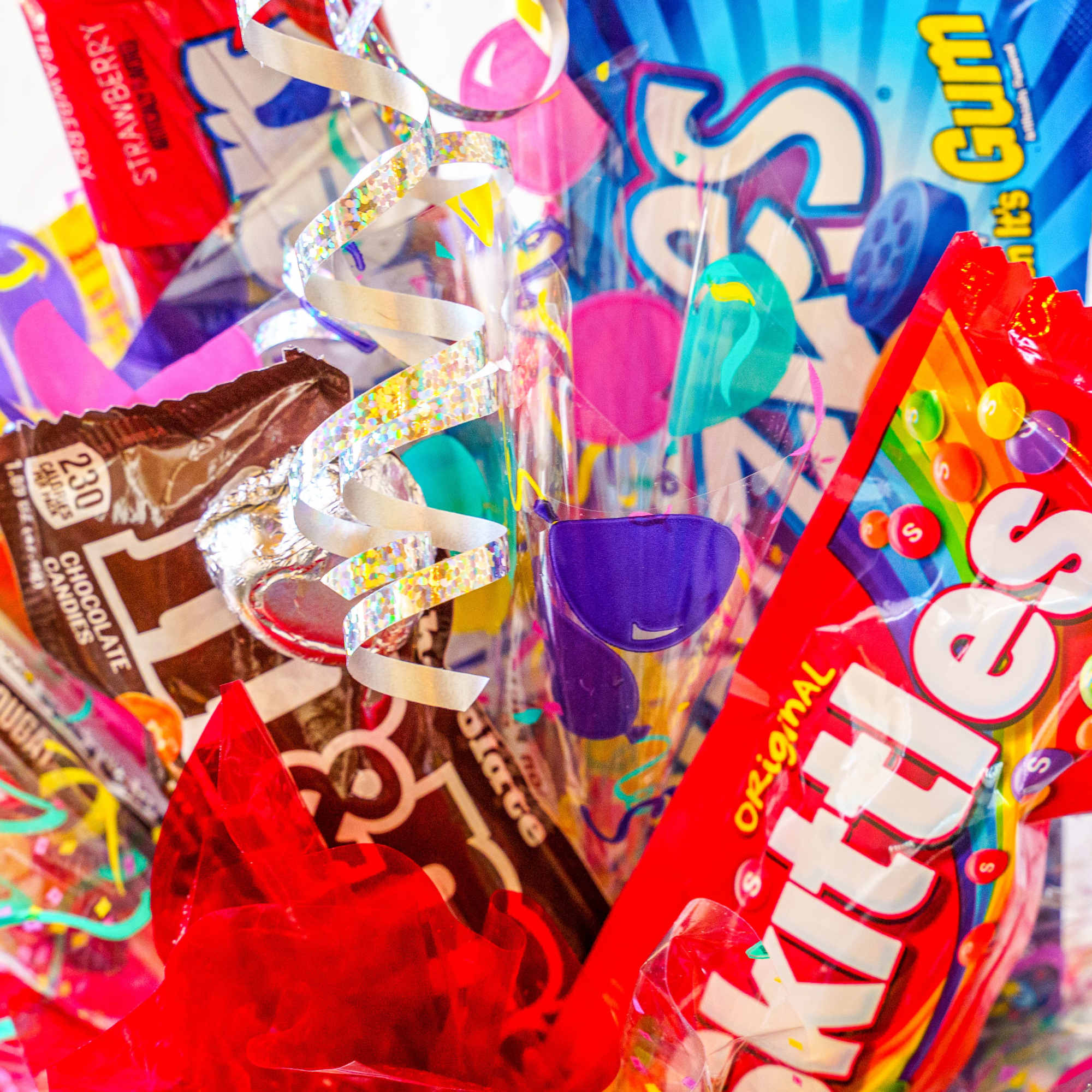 Assorted candy bags with curling ribbons and confetti