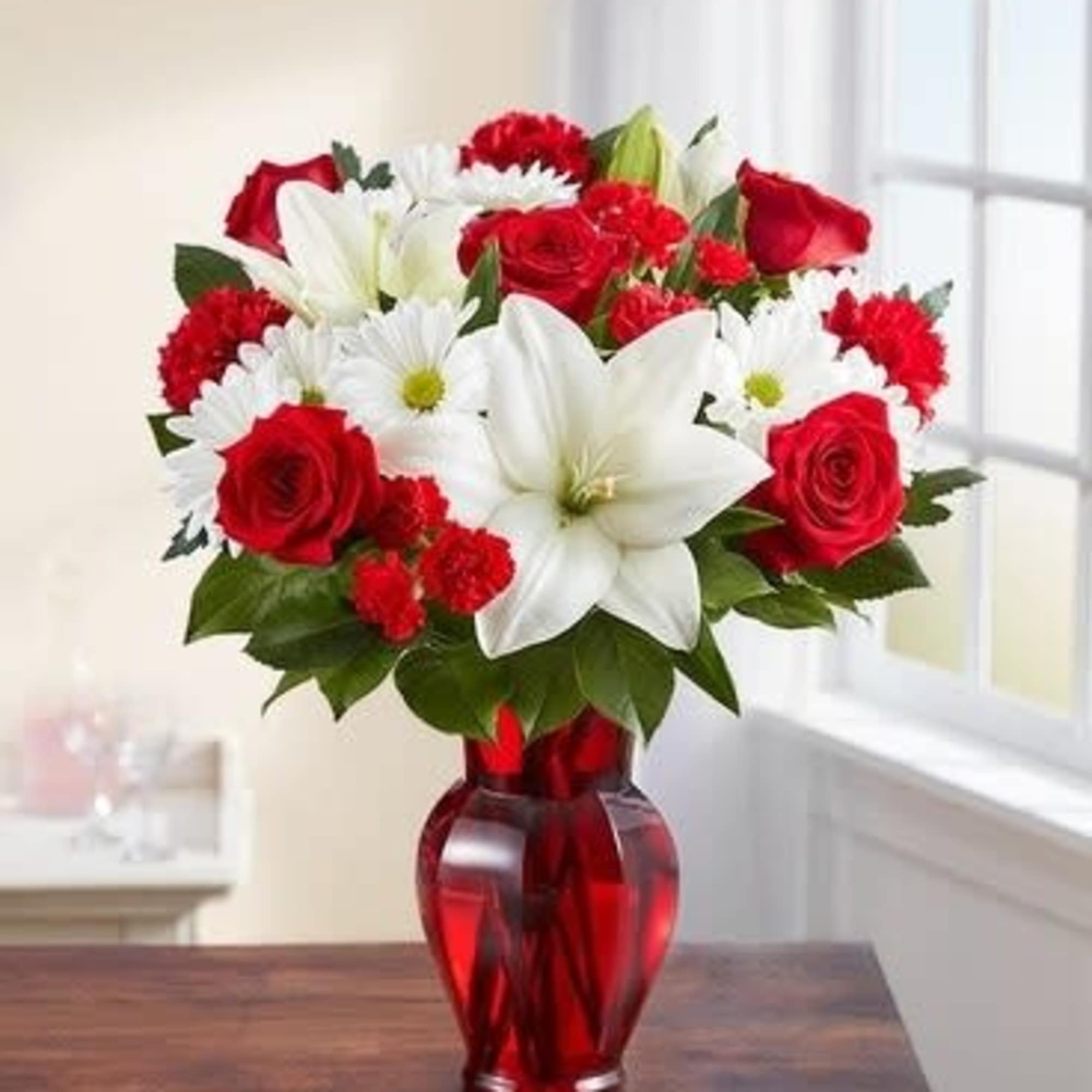 Red roses and white lilies in a red glass vase, photo 2 of 3