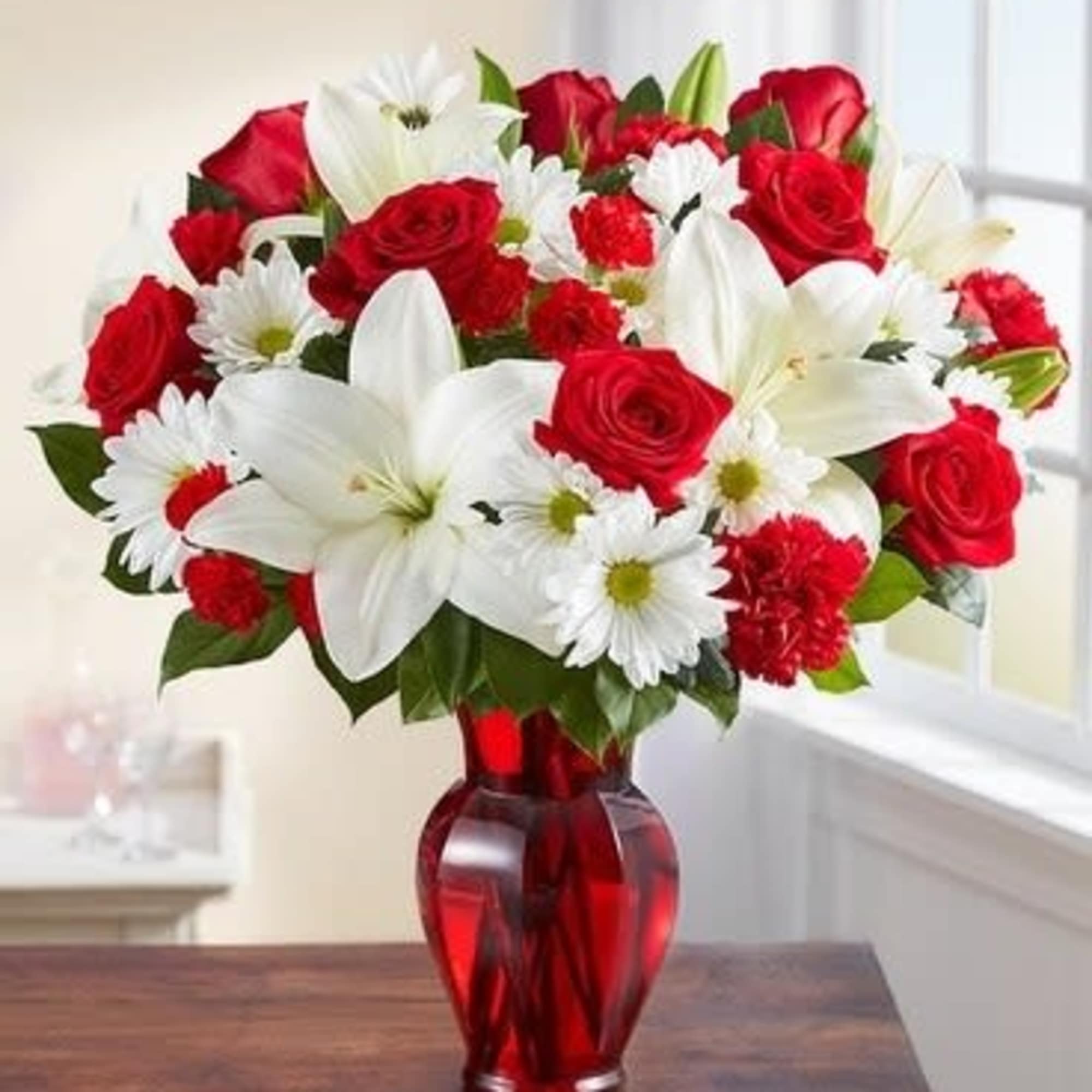 Red roses and white lilies in a red glass vase, photo 3 of 3