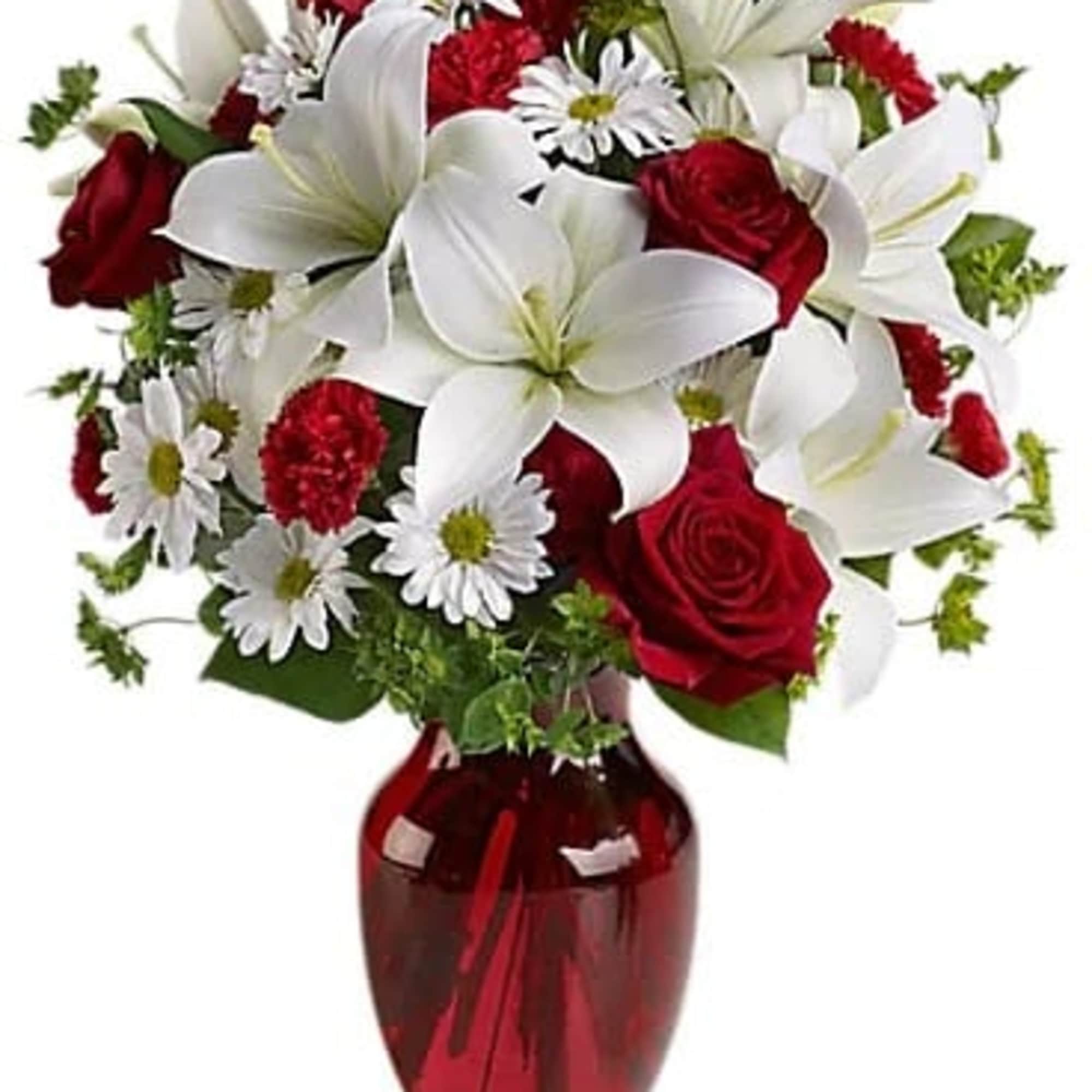 Red roses and white lilies in a red glass vase, photo 2 of 3