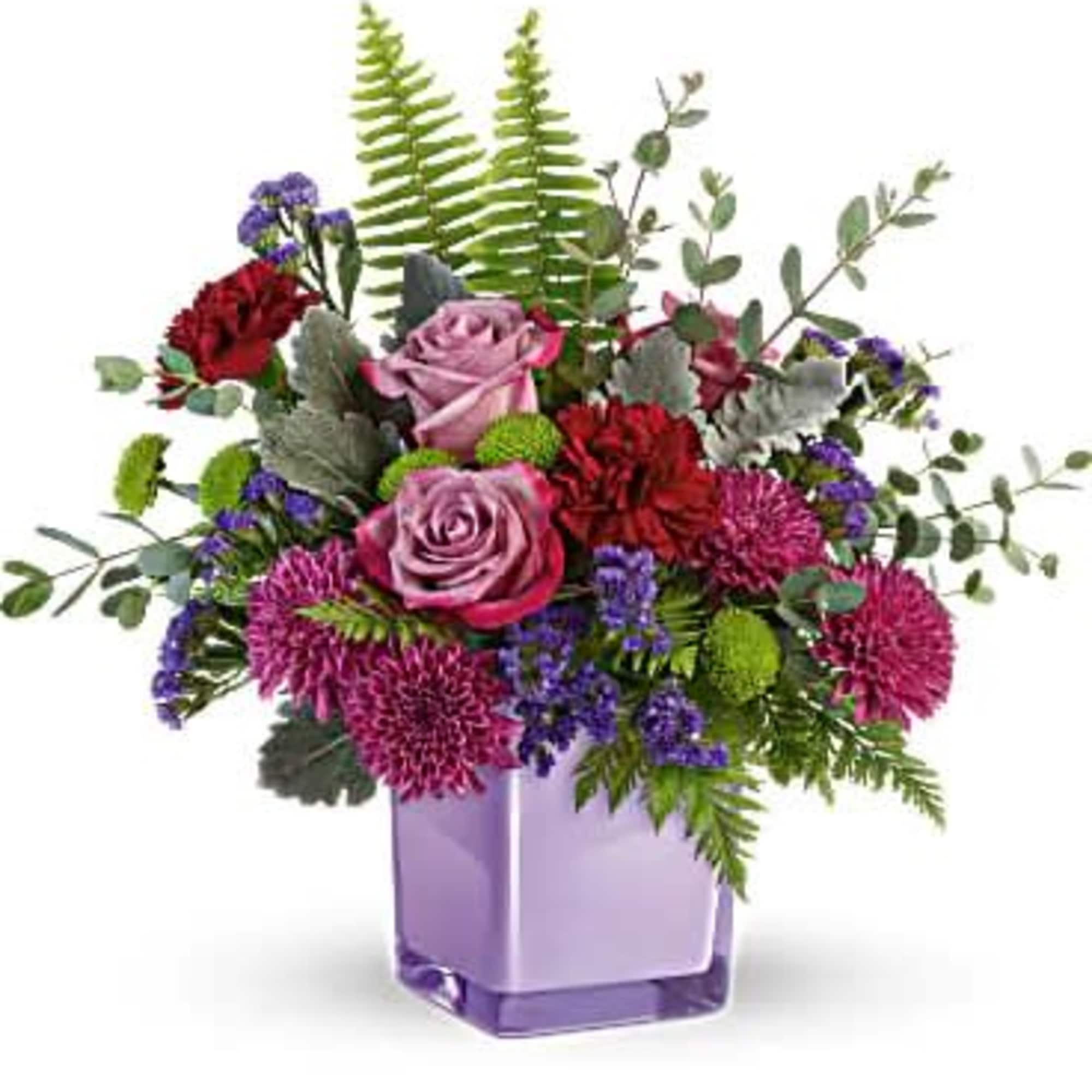 Purple and pink flower arrangement in a lavender vase