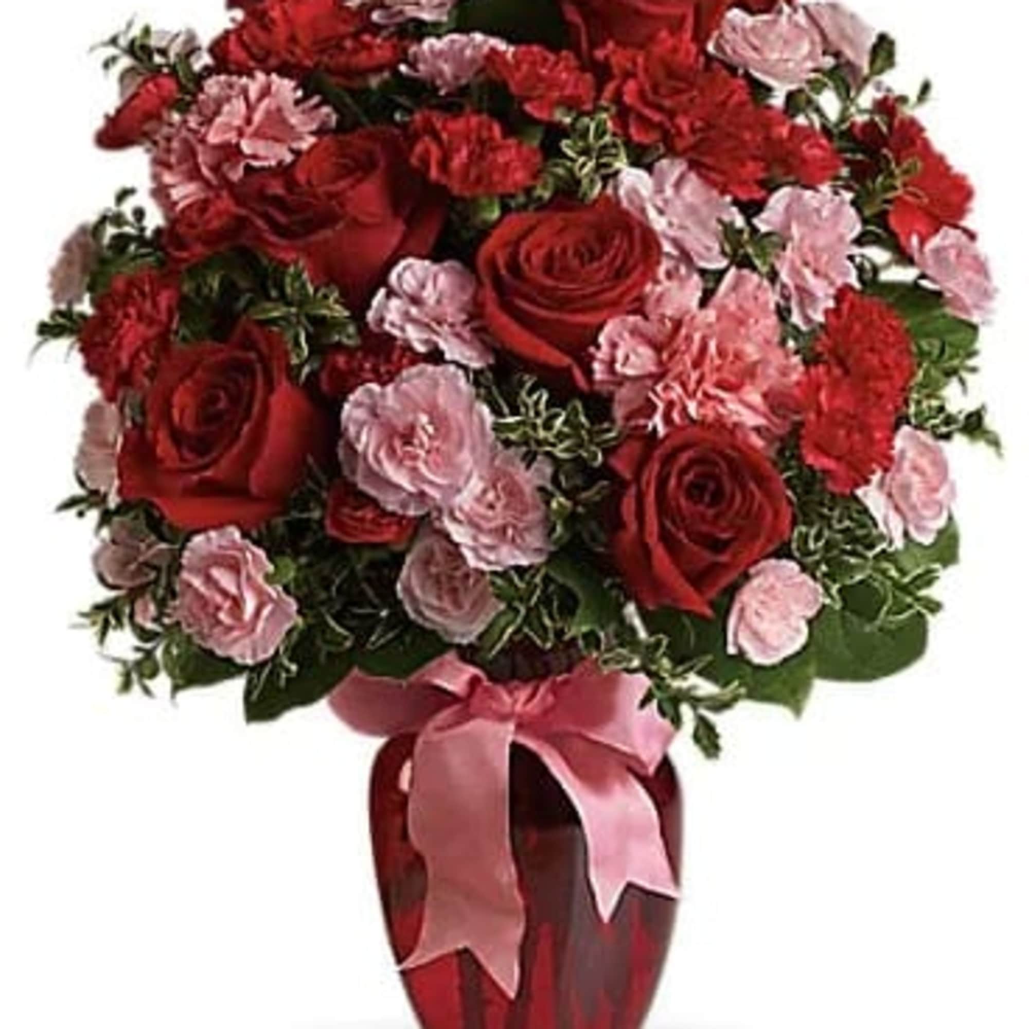Red roses and pink carnations in a red vase with a pink ribbon, photo 3 of 3