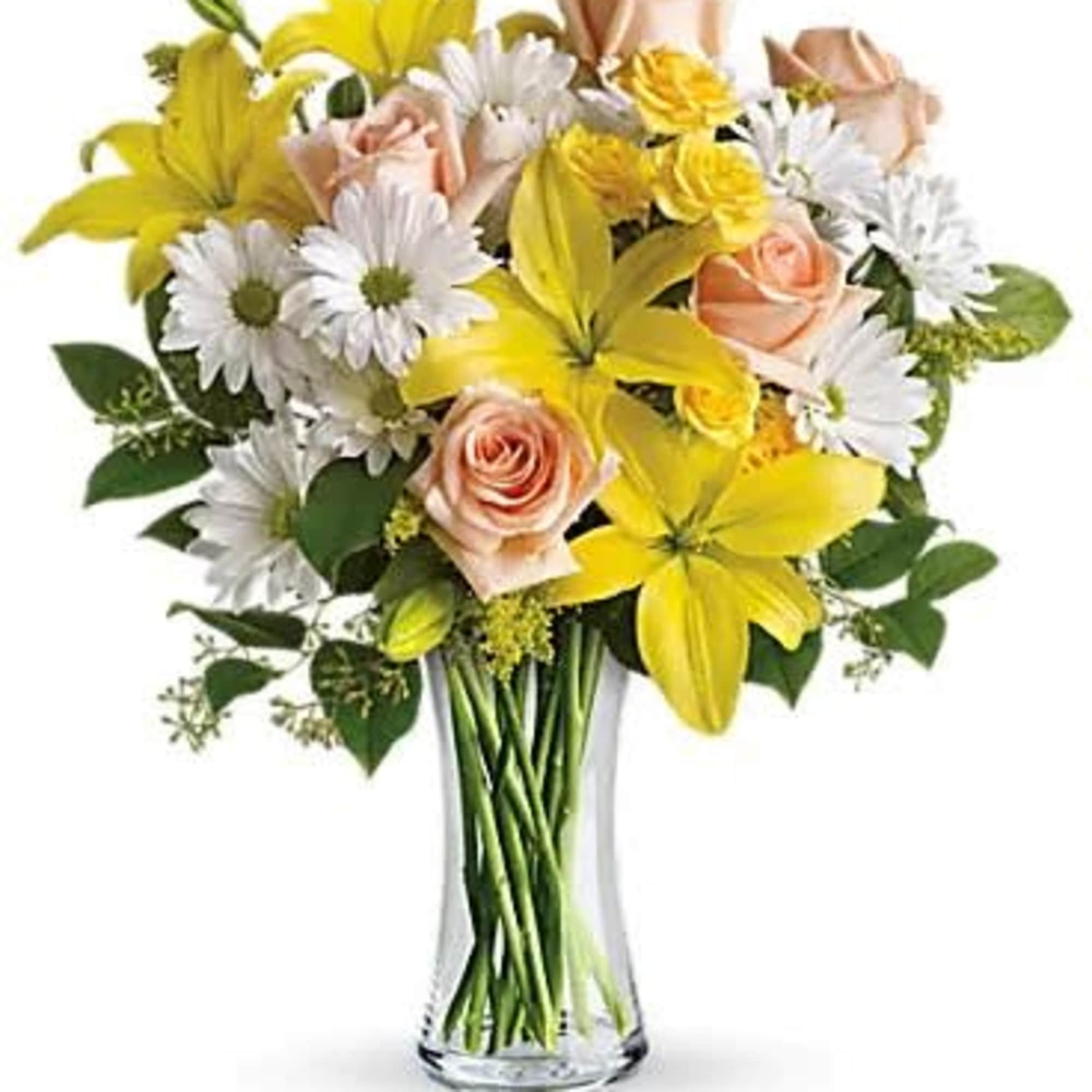 Bouquet of yellow lilies, peach roses, and white daisies in a glass vase