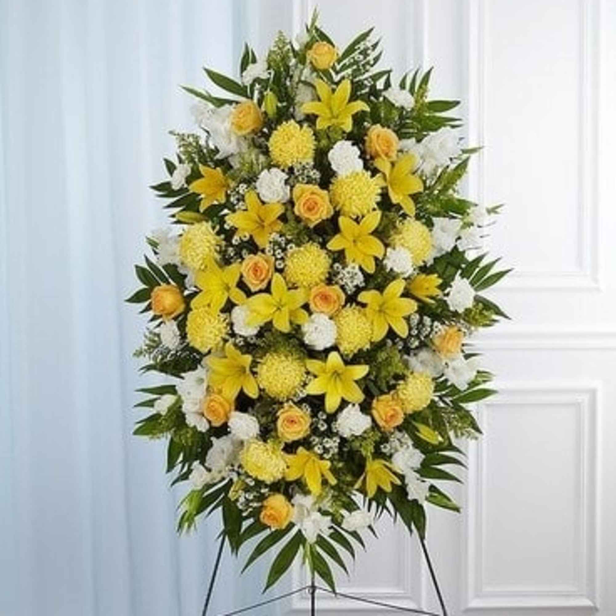 Standing yellow and white floral spray on an easel