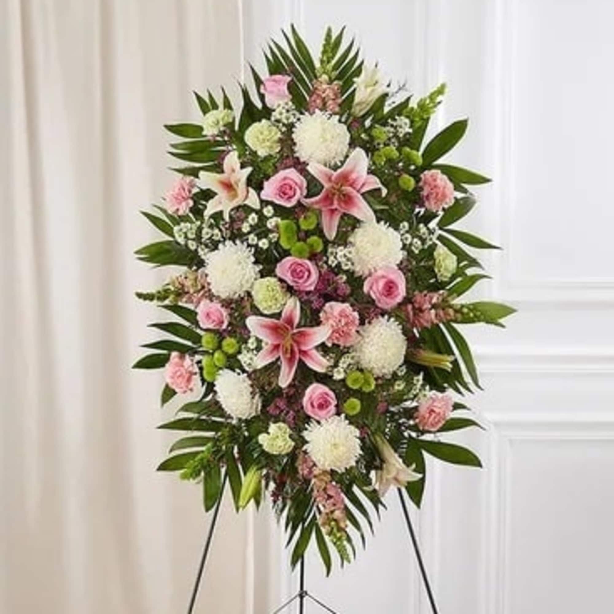 Standing floral spray with pink and white flowers on an easel