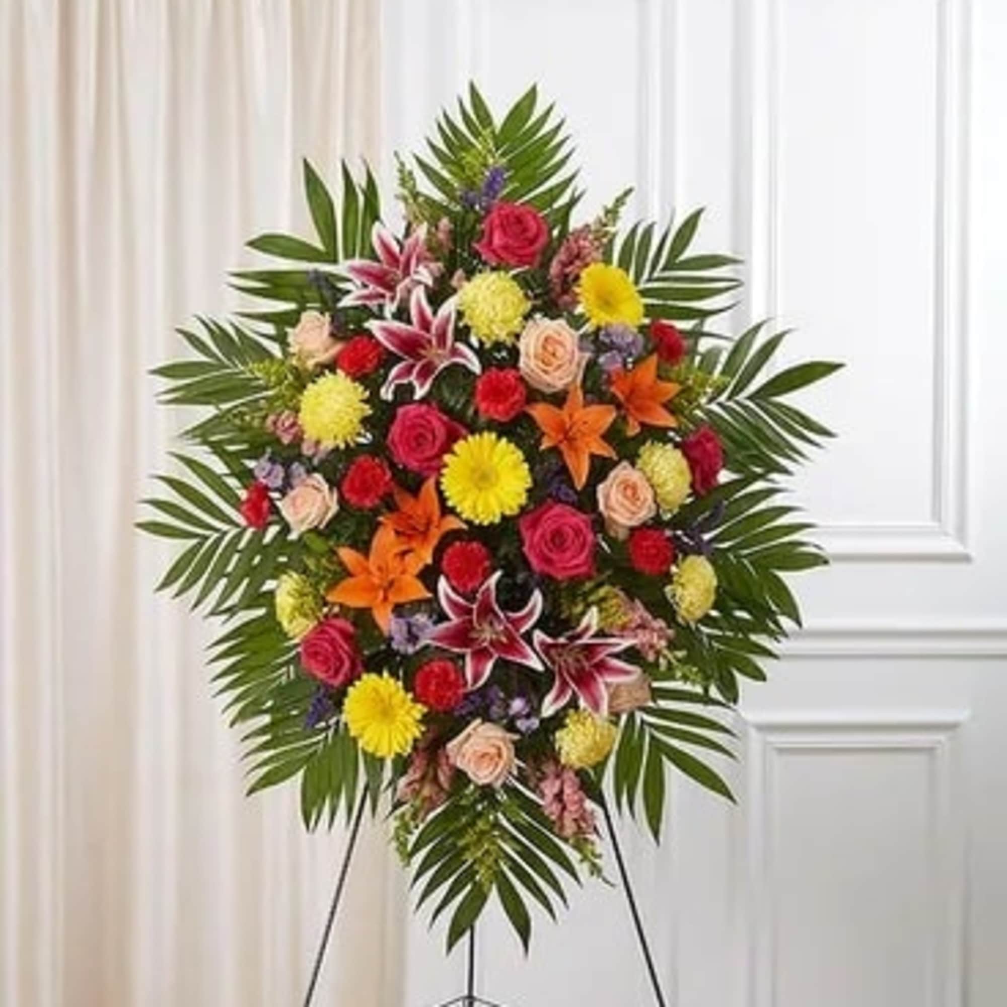 Standing floral spray with mixed bright flowers on an easel