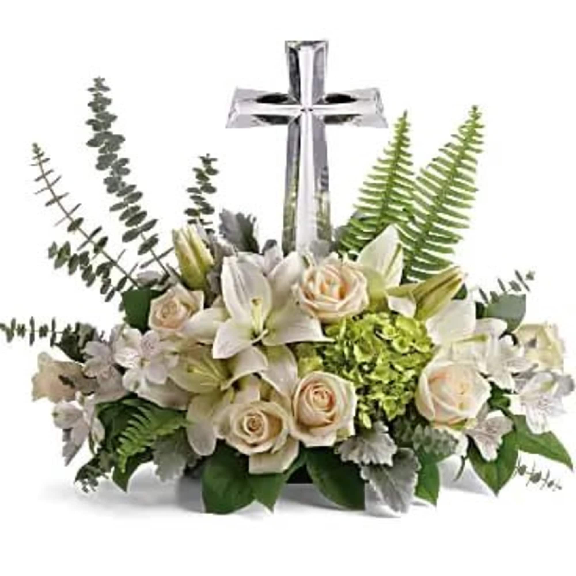 White floral arrangement with a silver cross centerpiece, photo 2 of 3