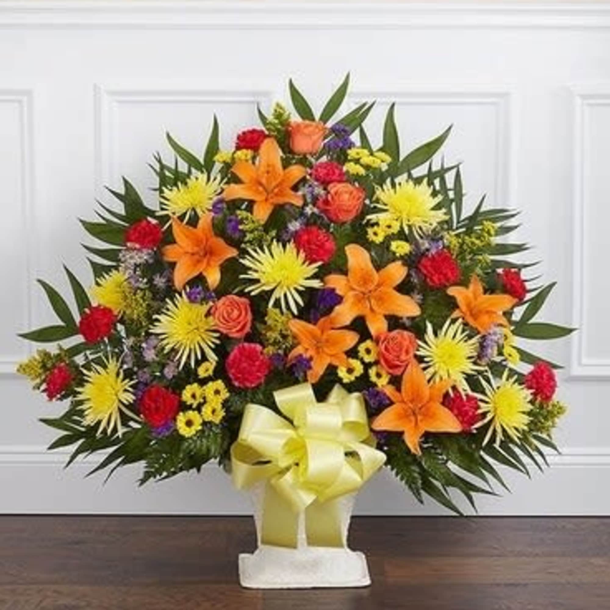 Bright mixed flower standing spray with orange lilies and yellow blooms