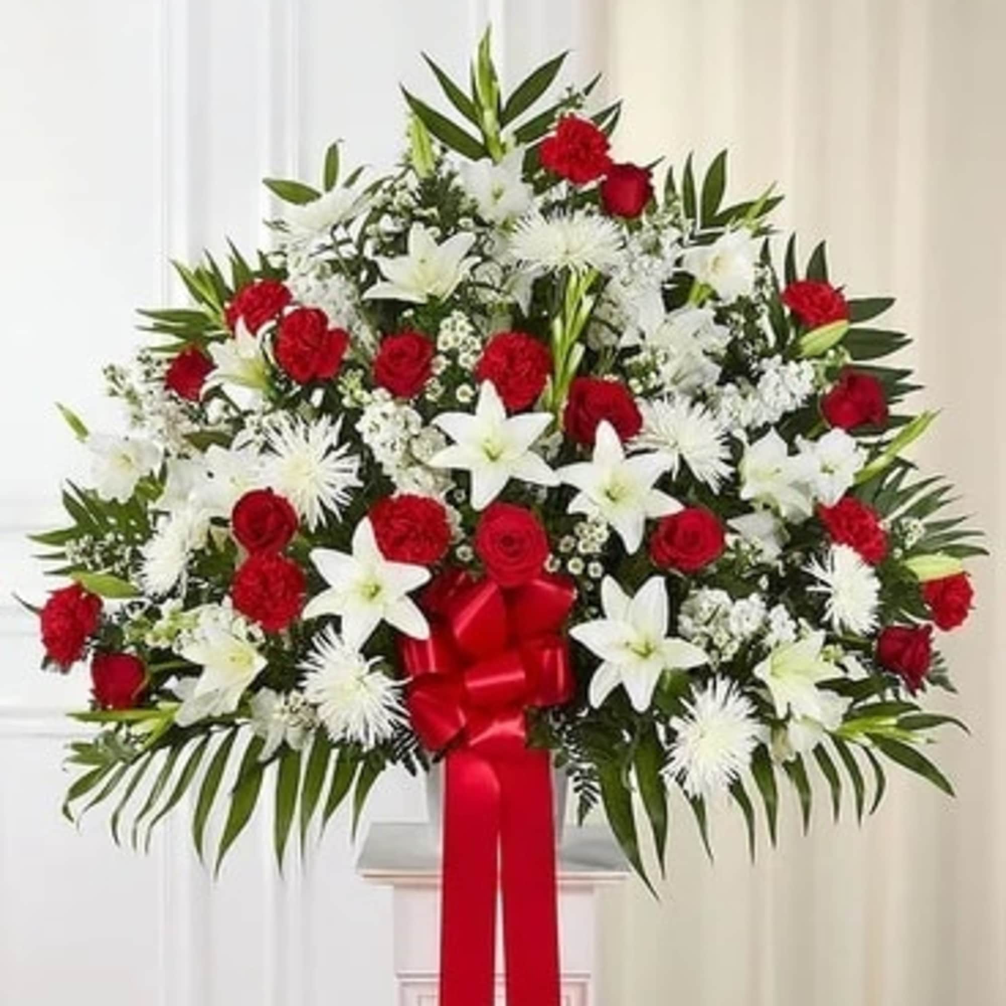 Standing floral spray with red roses and white lilies, tied with a red ribbon, photo 3 of 3